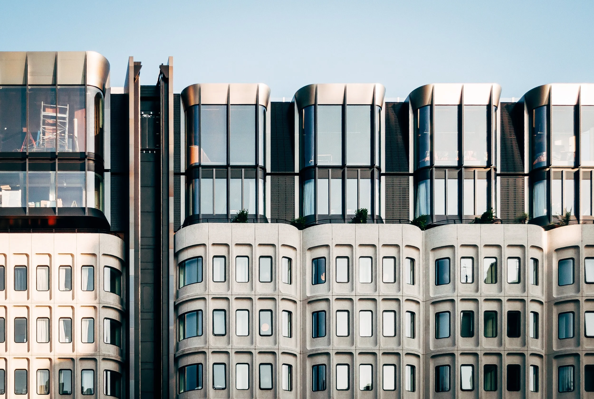 beautiful-wide-shot-modern-white-architecture-with-large-glass-windows-clear-blue-sky.jpg