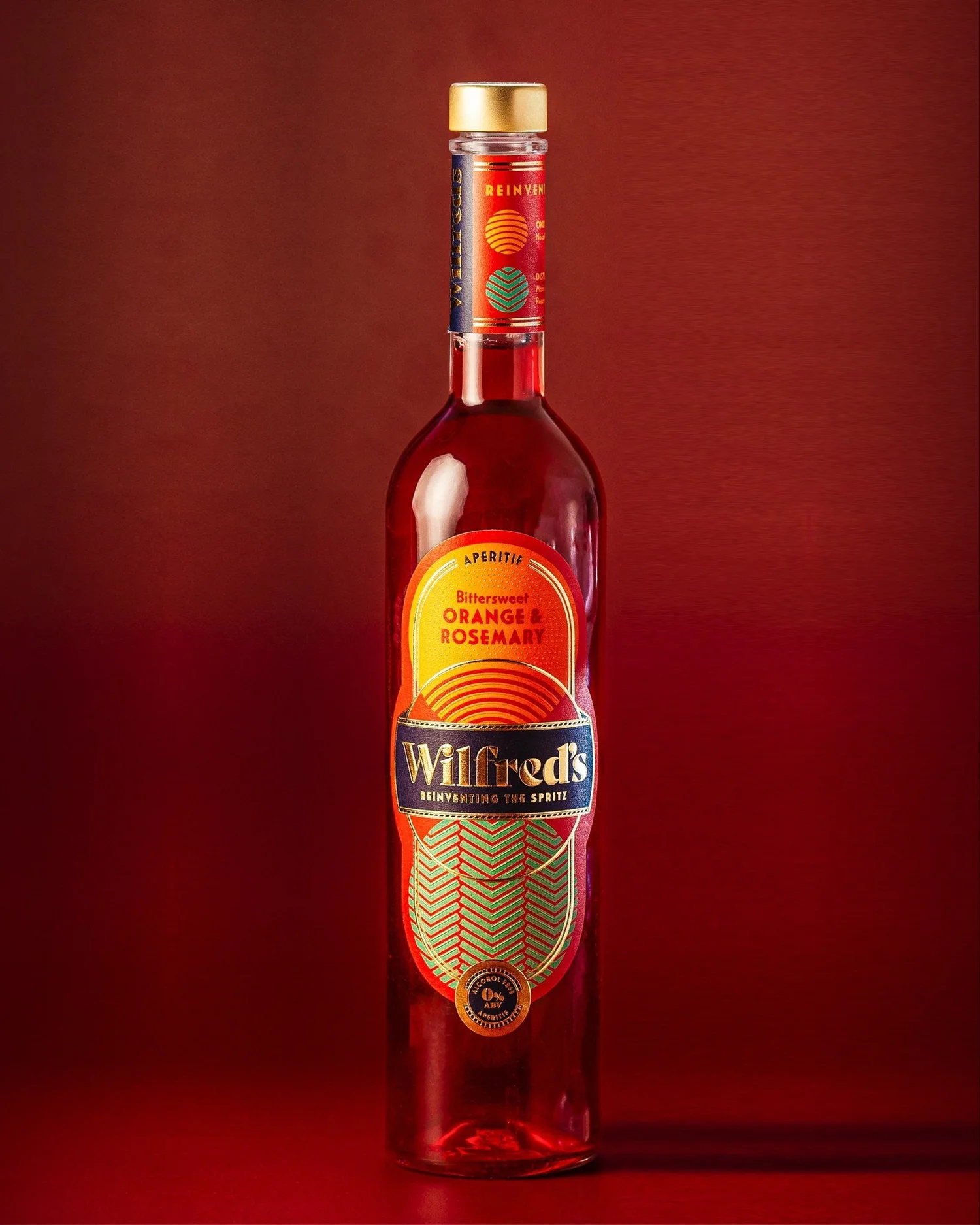 A bottle of Wilfred's Bittersweet Orange & Rosemary on a red background