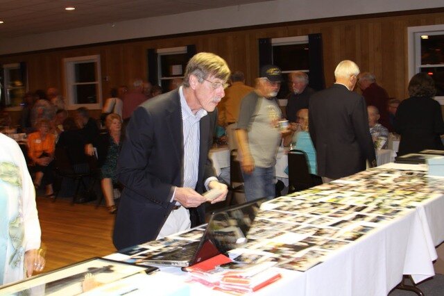"Butch" Jordan looking over the photos from the 2006 reunion. Pictures were provided by "Bud" Fisher.