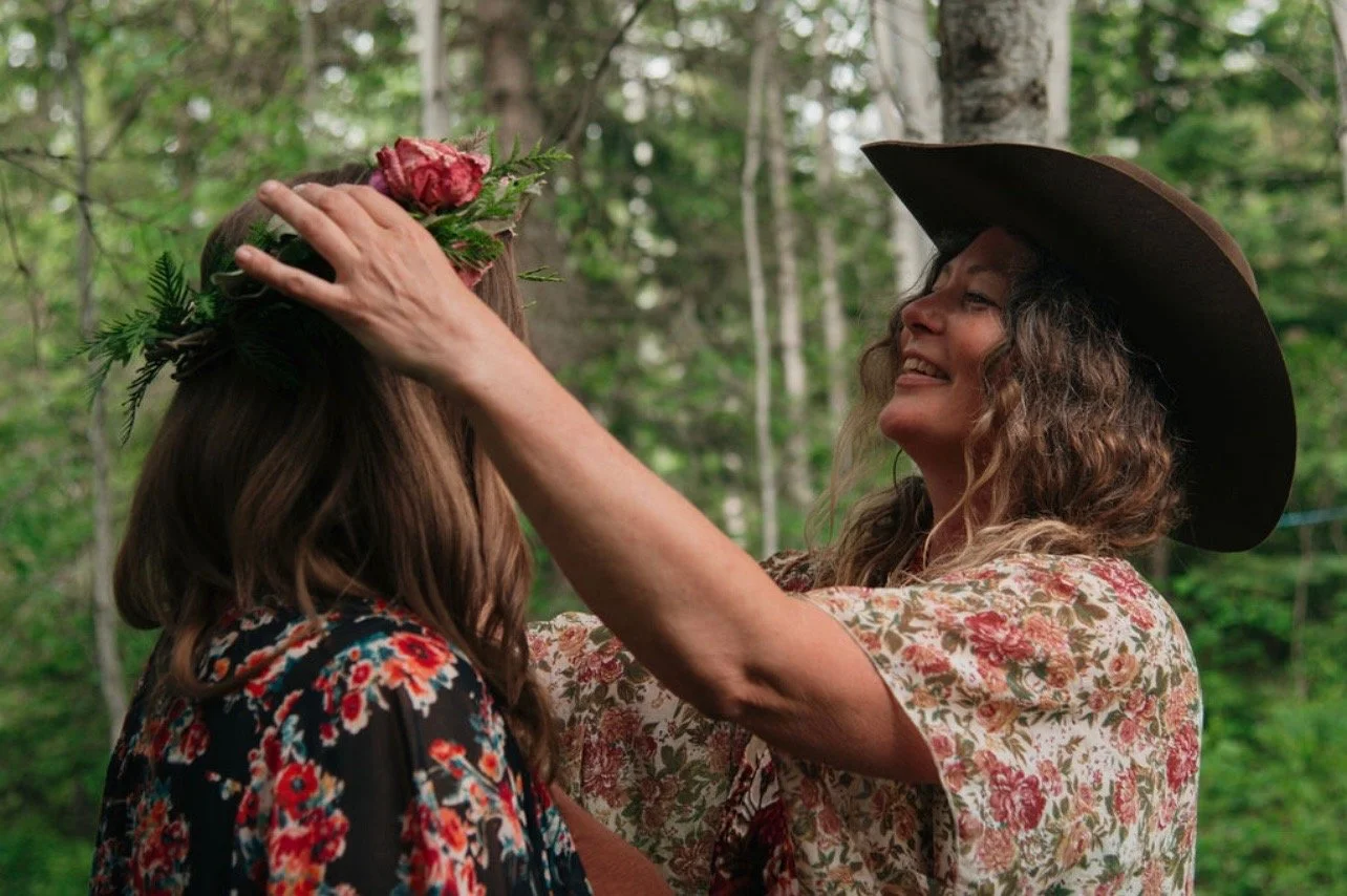 Girl placing flower crown on another girls head.JPEG