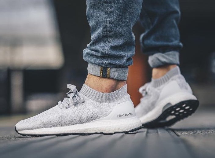 white uncaged ultra boost on feet