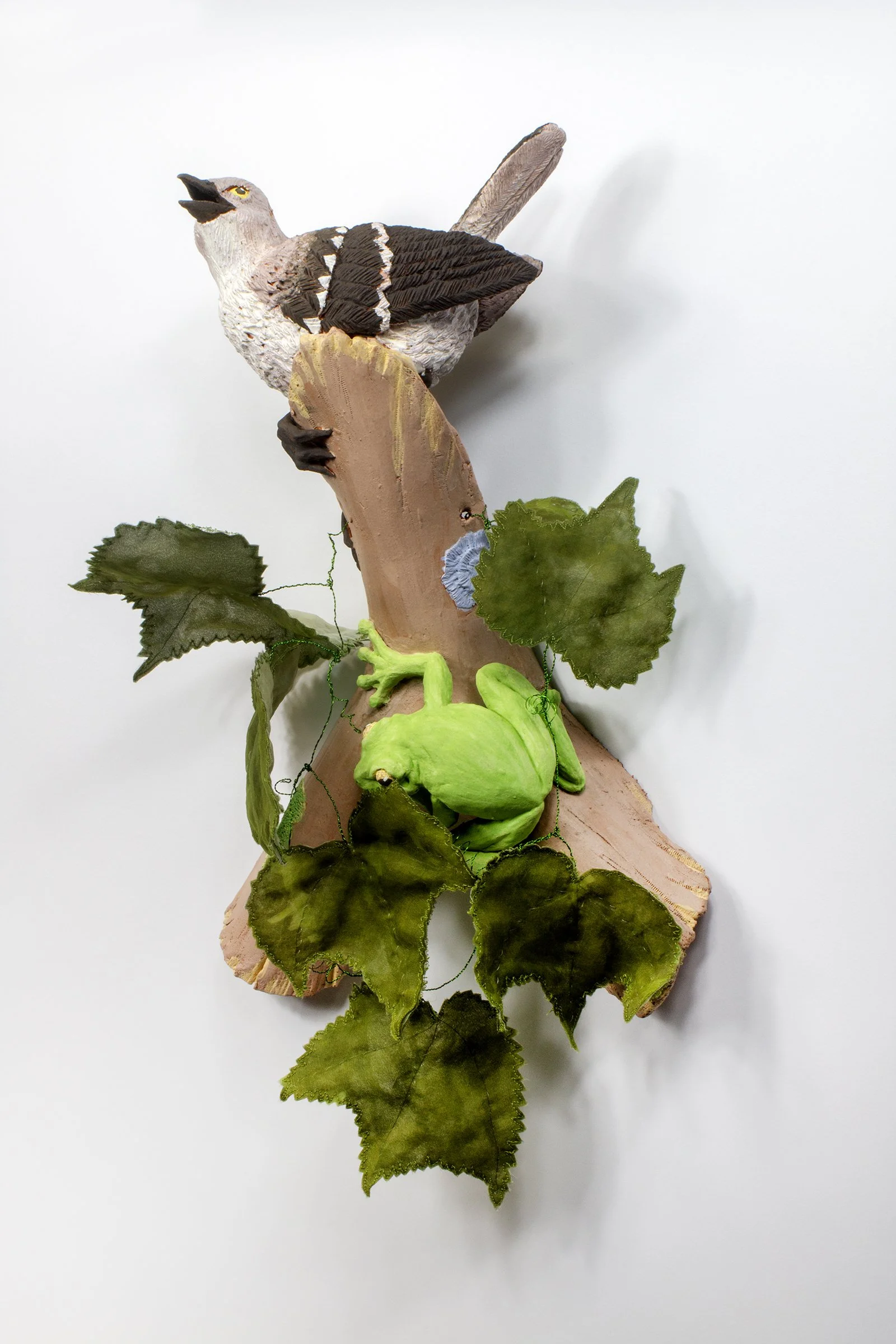 Portrait of a Sabal: Rise and sing (Northern Mockingbird, American green tree frog, Wild grape vine)
2026
17 H  x 12 W x 5 D
Lizella, terra sigillata, underglaze, hand dyed silk organza, copper wire 
