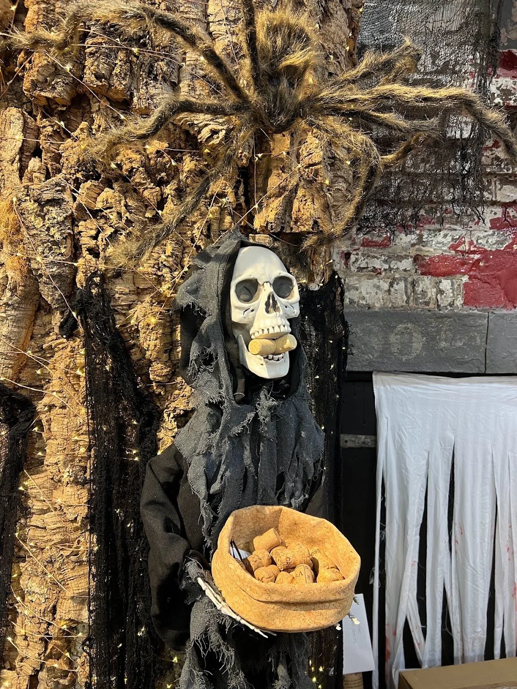 Skeleton standing in front of a cork tree with corks in its mouth