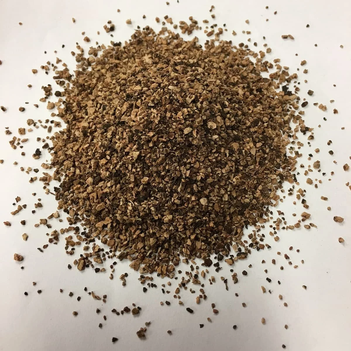 Pile of small grain sizes of natural granulated cork for use as infill material