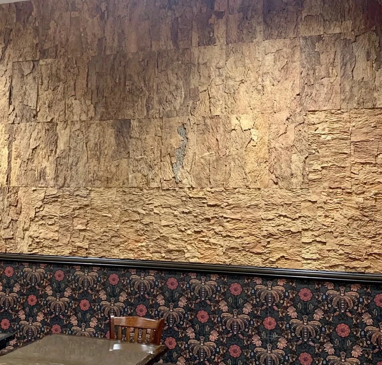 Natural cork wall tiles installed in a restaurant showing the texture of the cork wall