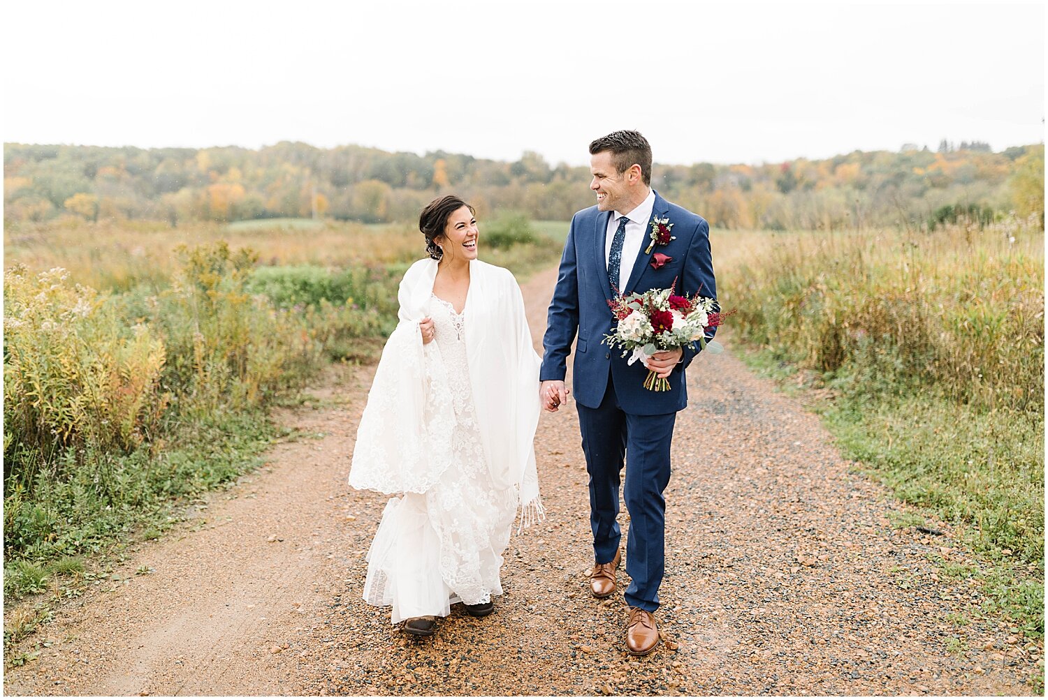  bride and groom holding hands 