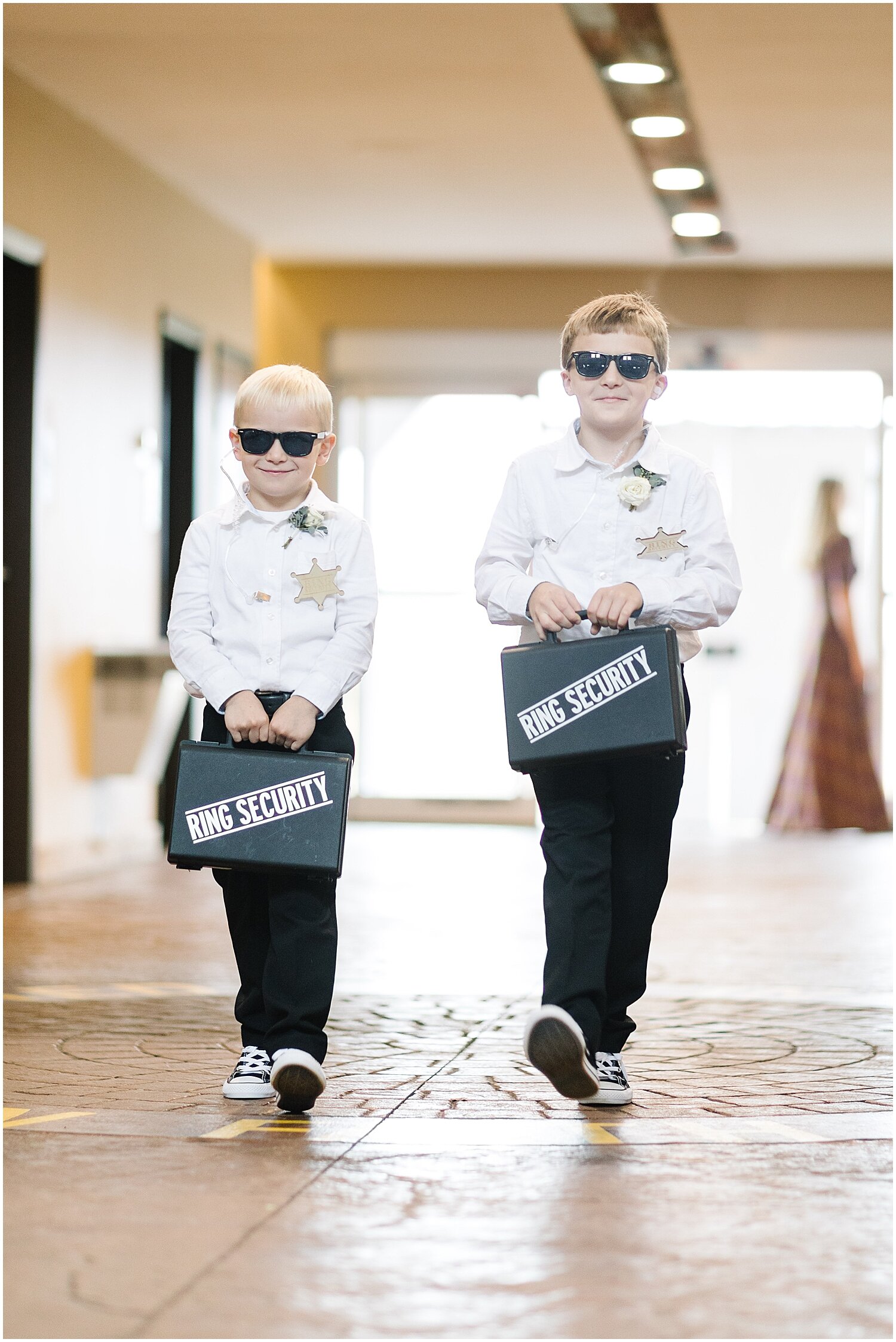  two ring bearers walking down the aisle 