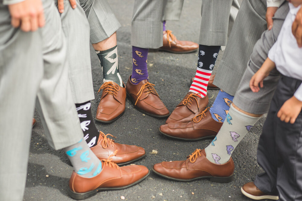  groom and groomsmen wearing silly socks 