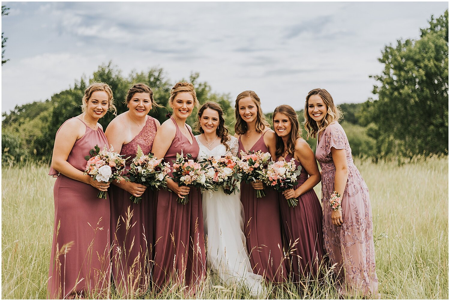  bride and her bridesmaids holding their wedding bouquets 