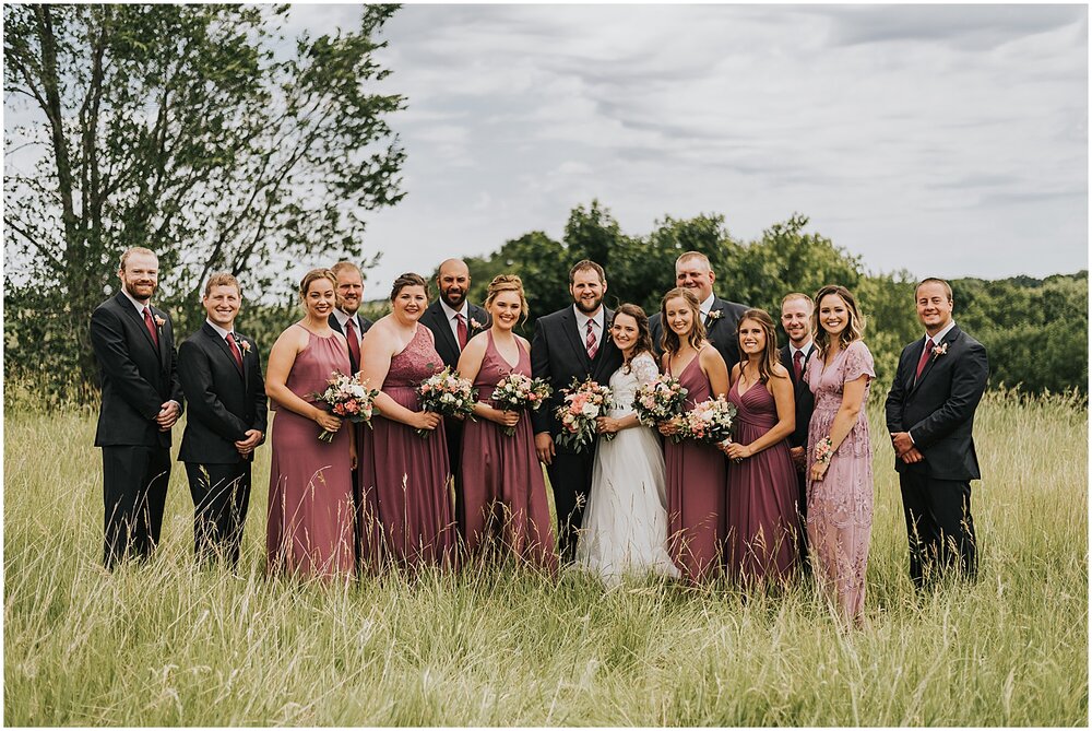  bride and groom with their wedding party 