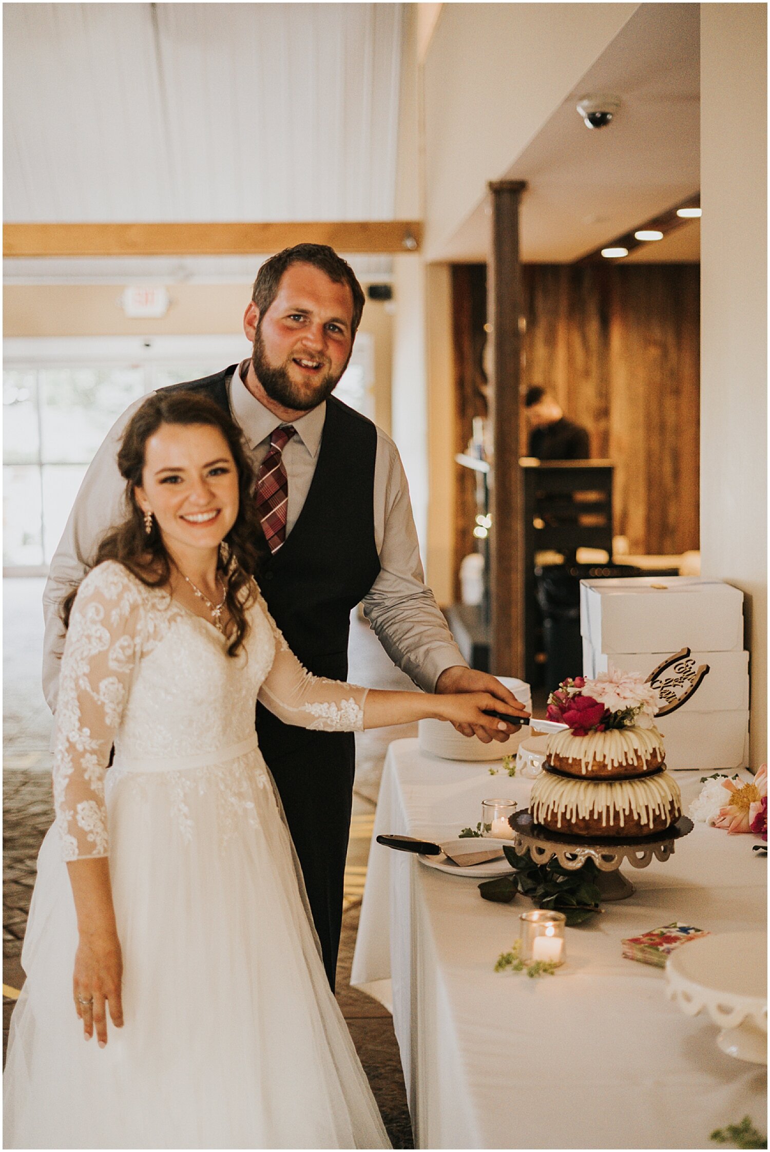  bride and groom cut their wedding cake 