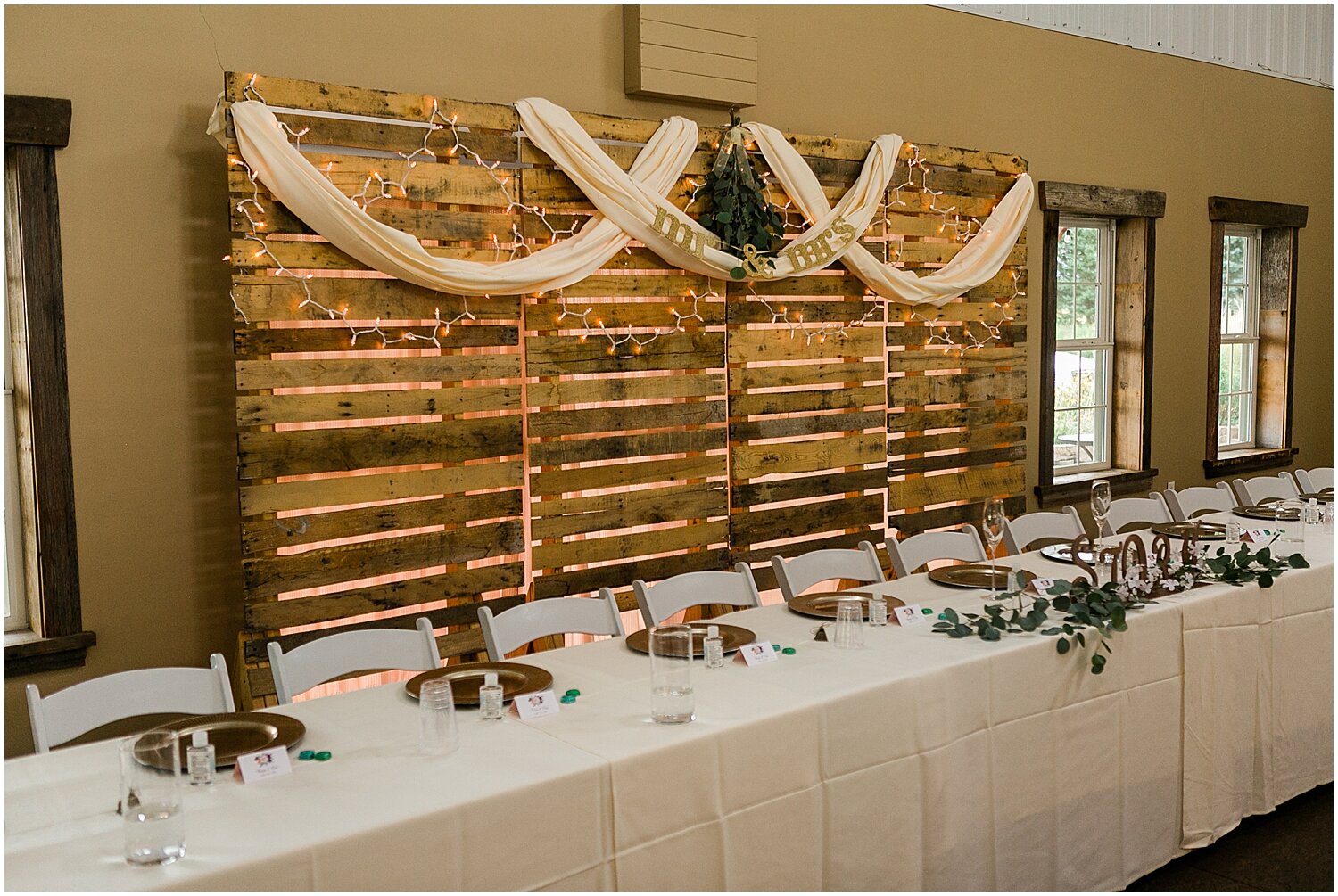  Head table for the couple and wedding party as well as the backdrop  