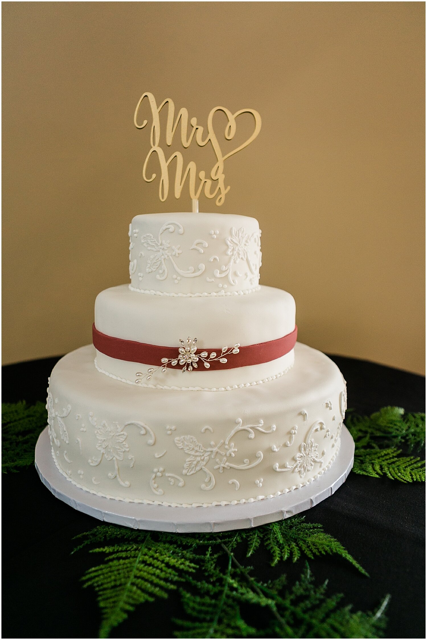  white wedding cake with a Mr and Mrs Sign 