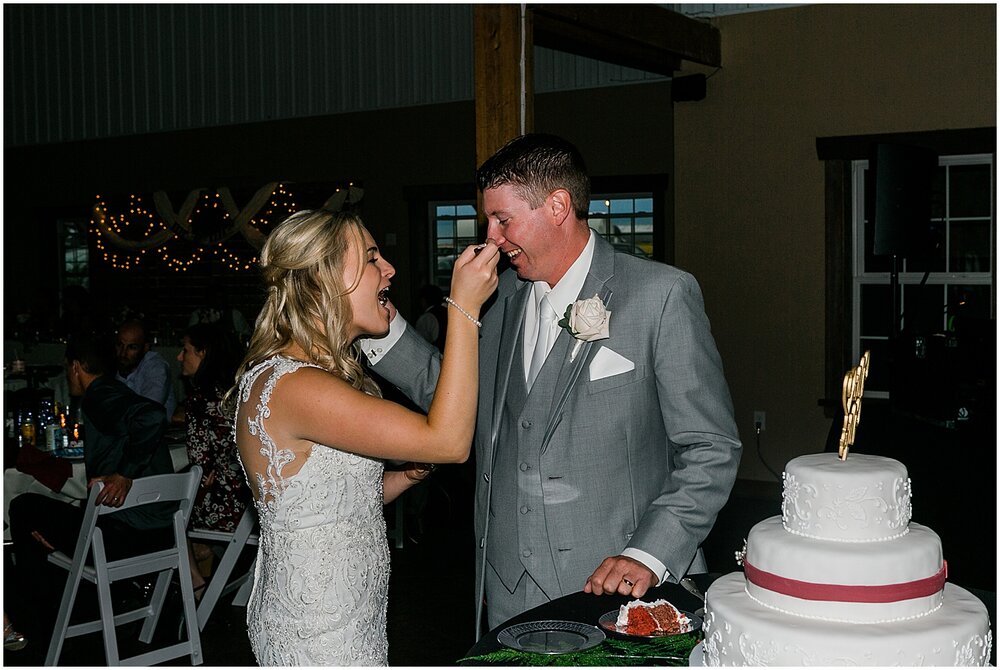  bride and groom cutting their wedding cake 