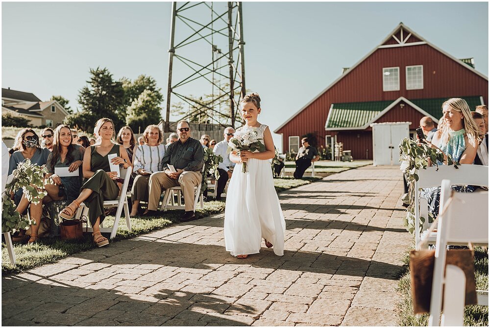  flower girl walking down the aisle  