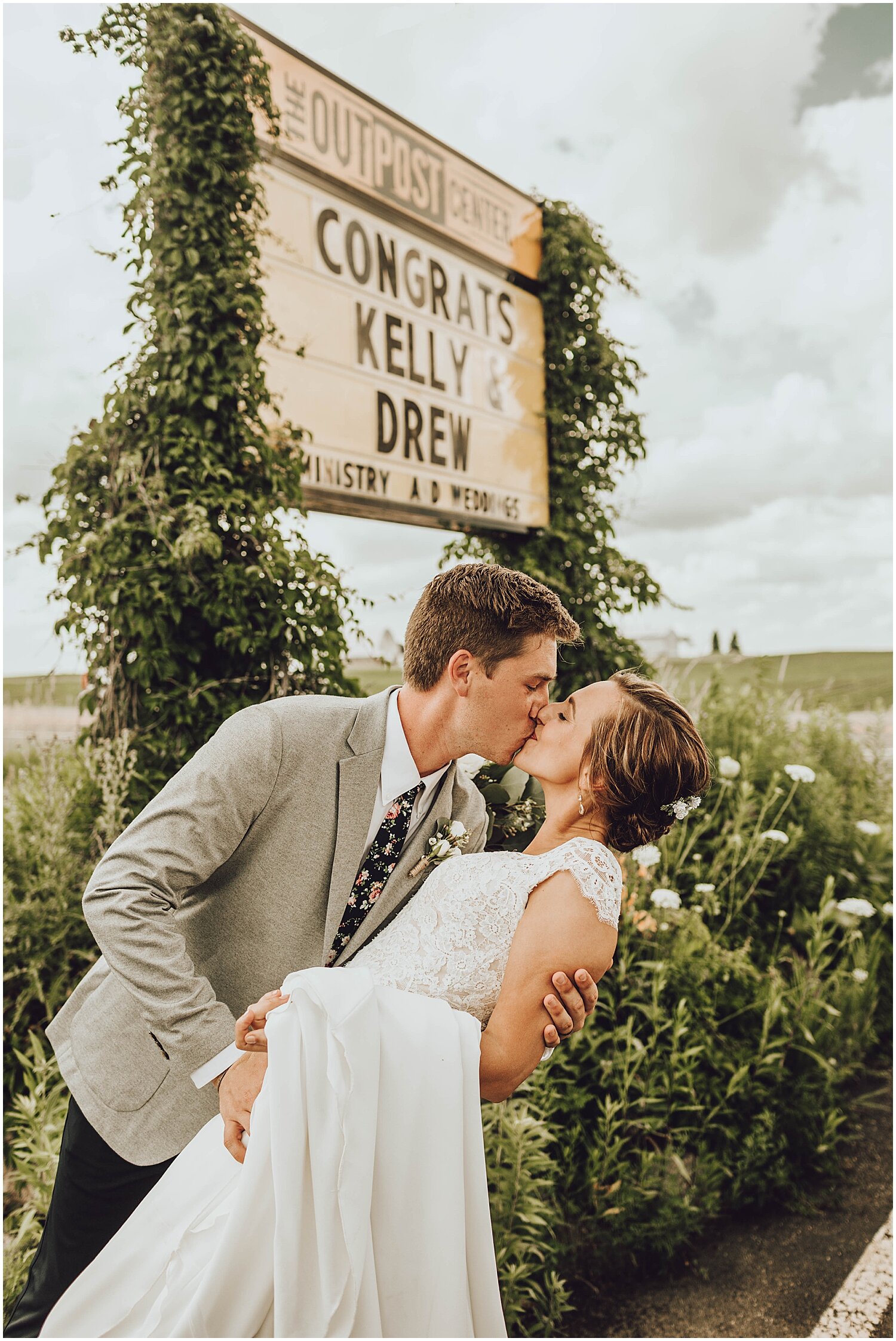  bride and groom posing in front of the congratulations sign 