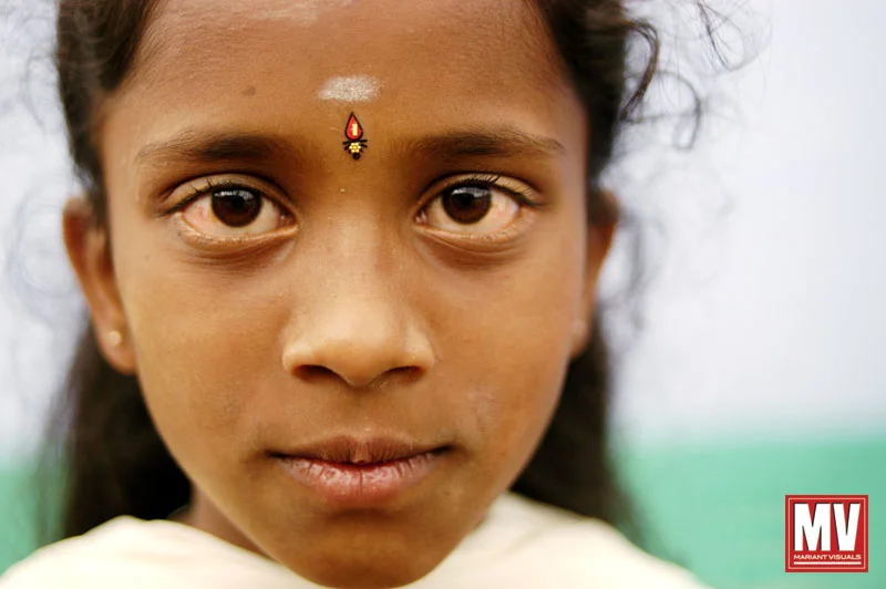 A young girl is seen at a small village in the Nilgiris region of Tamil Nadu, India during a firewalking festival.