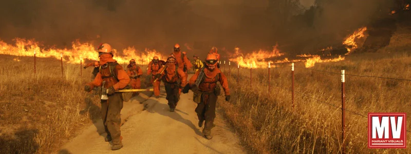 A handcrew runs to escape from a rapidly advancing wildland fire as it flares up in stong winds in the foothills east of Santa Margarita, Calif. (AP Photo/Michael A. Mariant)