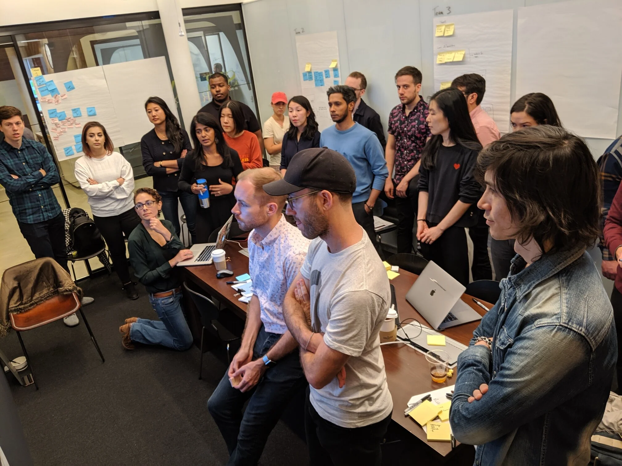 Facilitating a UX Studio session; the team stopped to listen to their teammate’s output was following an information design activity.