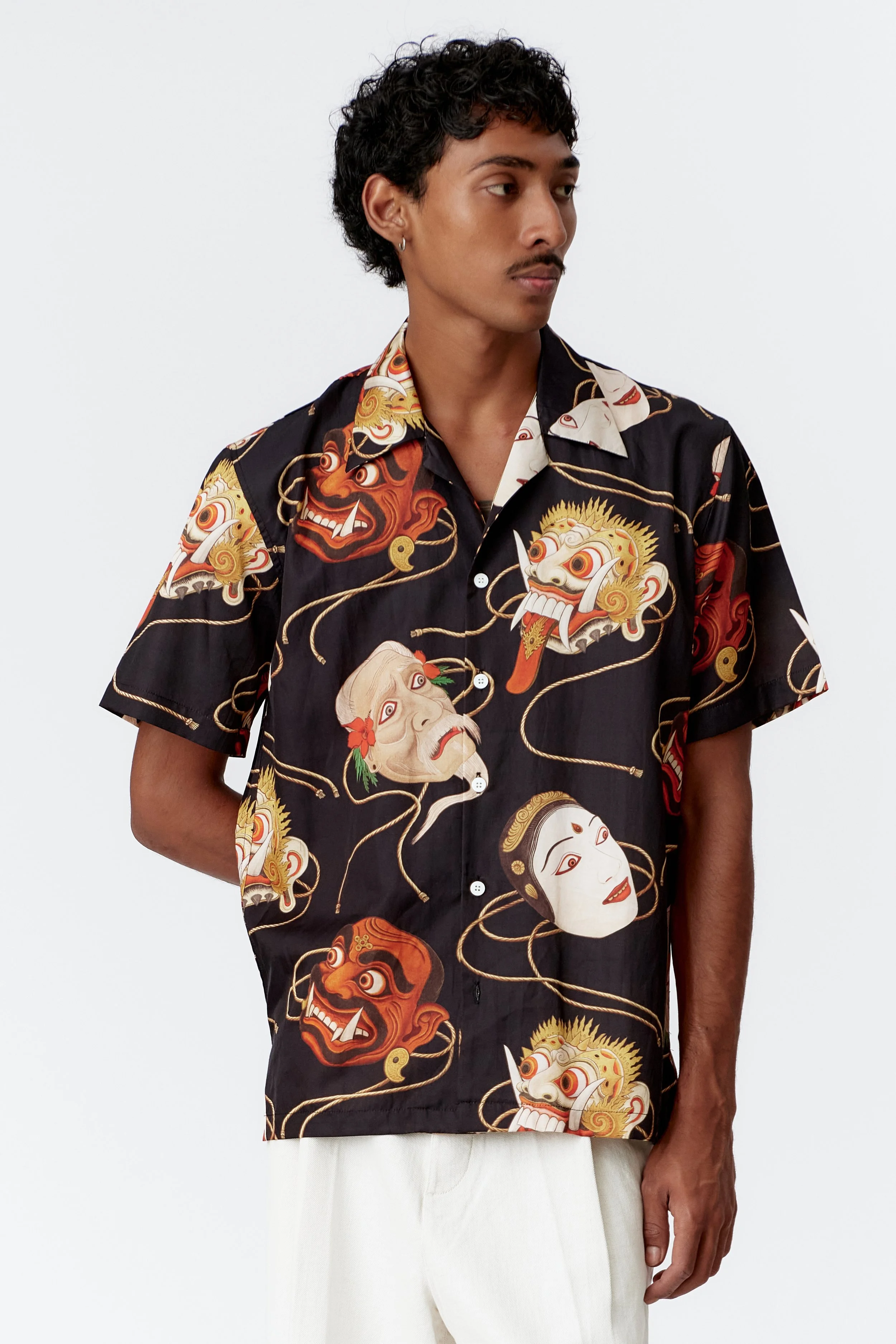 Close-up of Topeng mask artwork on black endless joy shirt