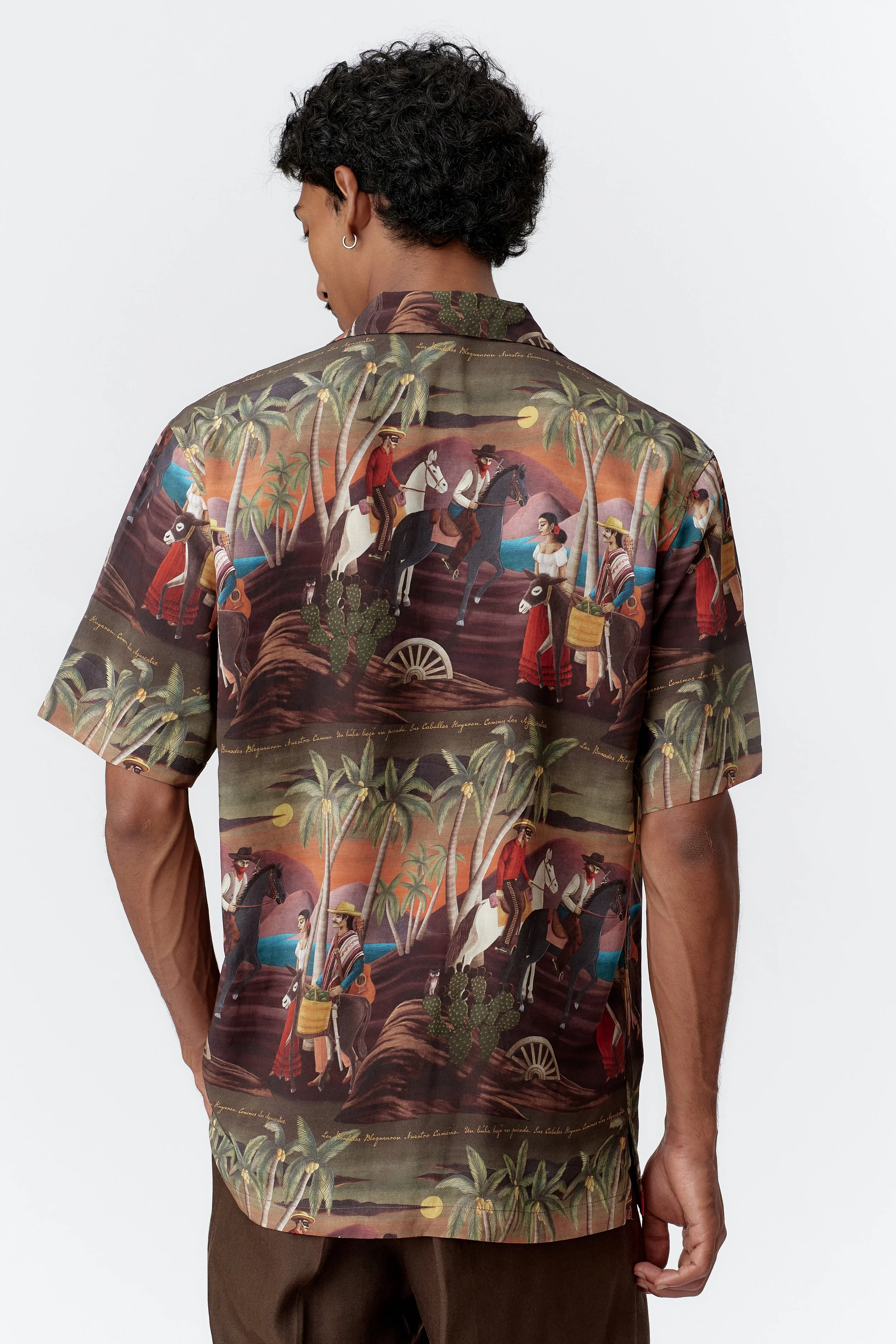 Back view of bottle green Bandito repeat shirt showing continuous desert landscape print