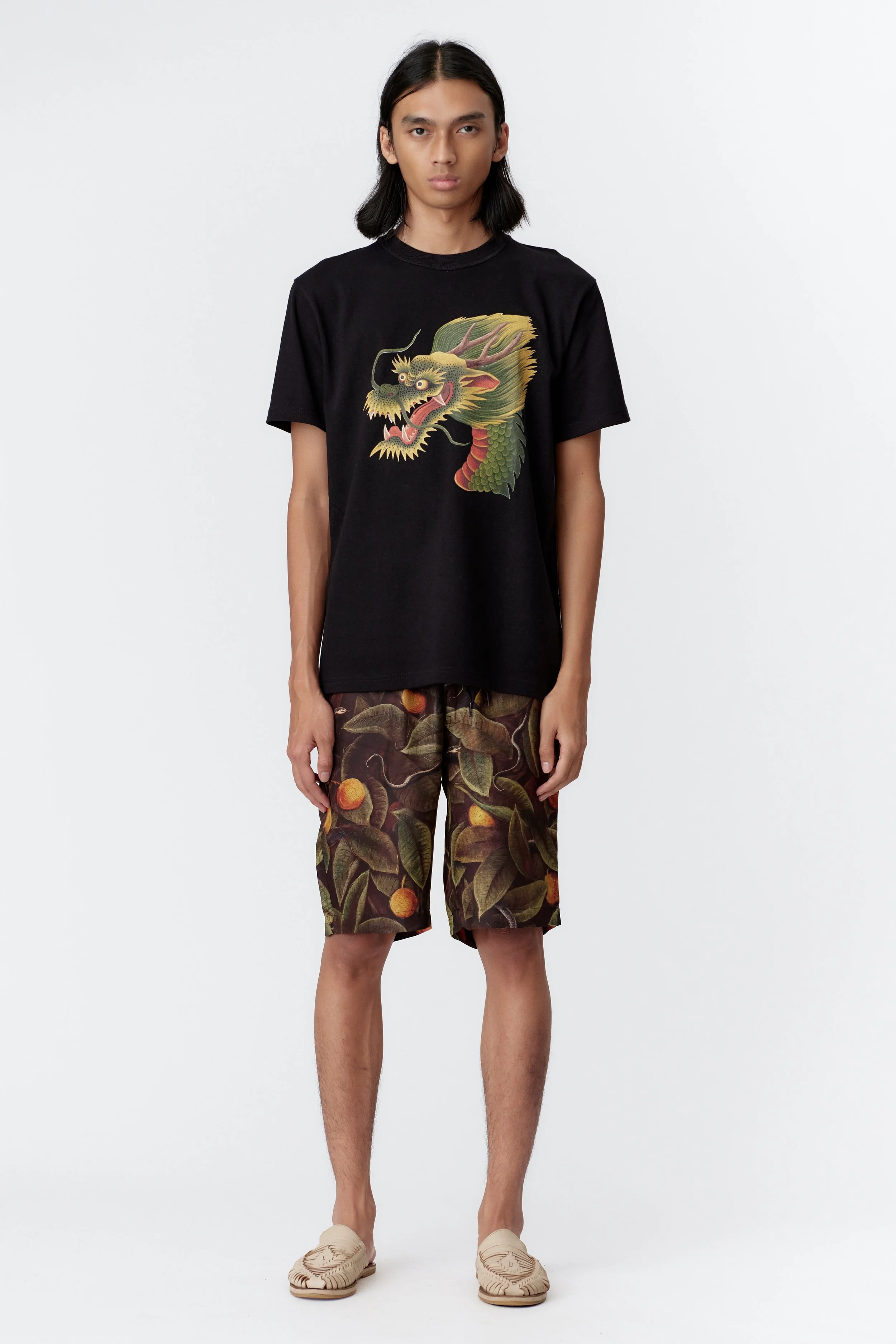 full view of model wearing monkey dragon artwork on black cotton t-shirt