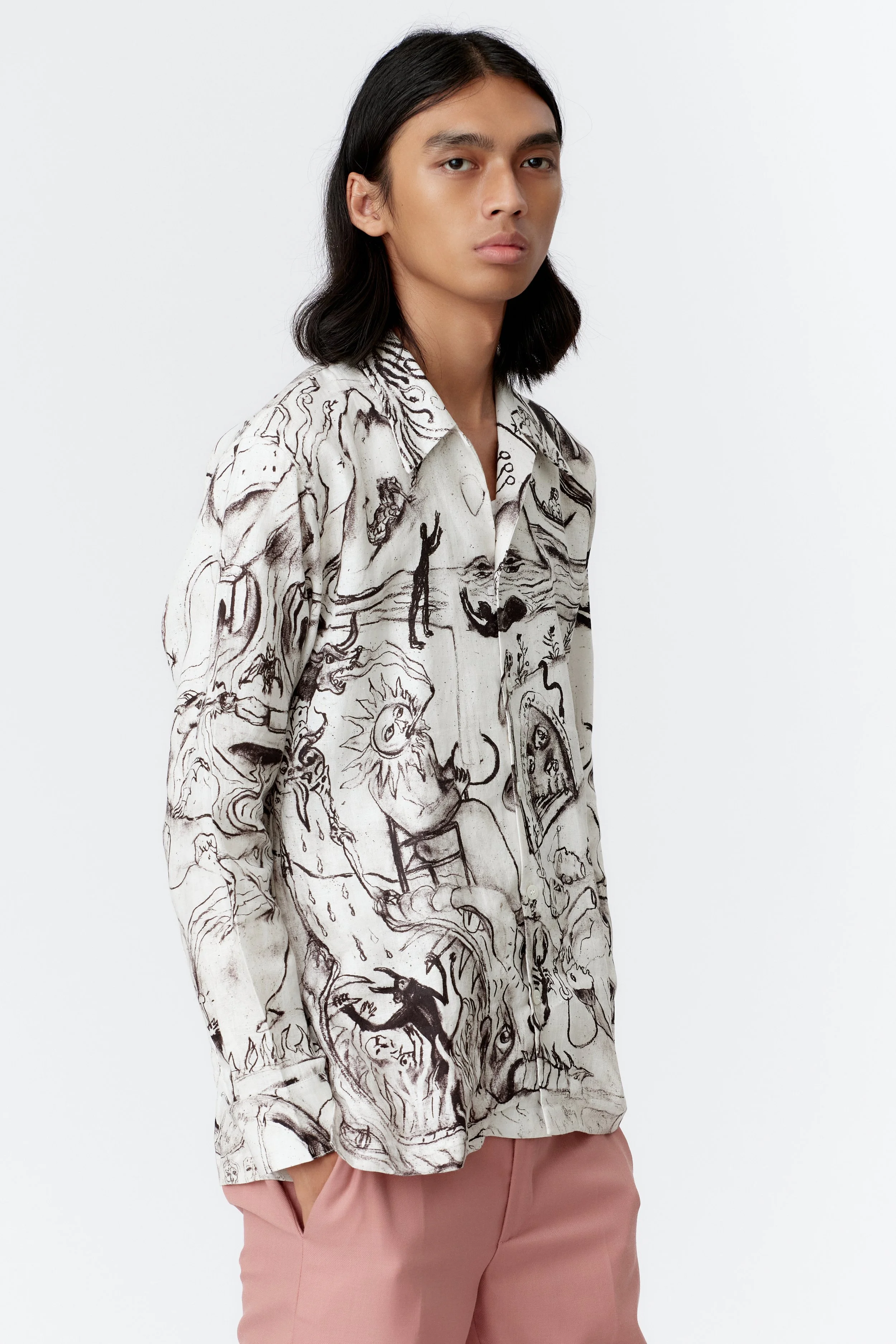 Close-up of ALCHEMY shirt front panel with detailed charcoal sketches of Mercurius, three-headed dragon, and alchemical motifs