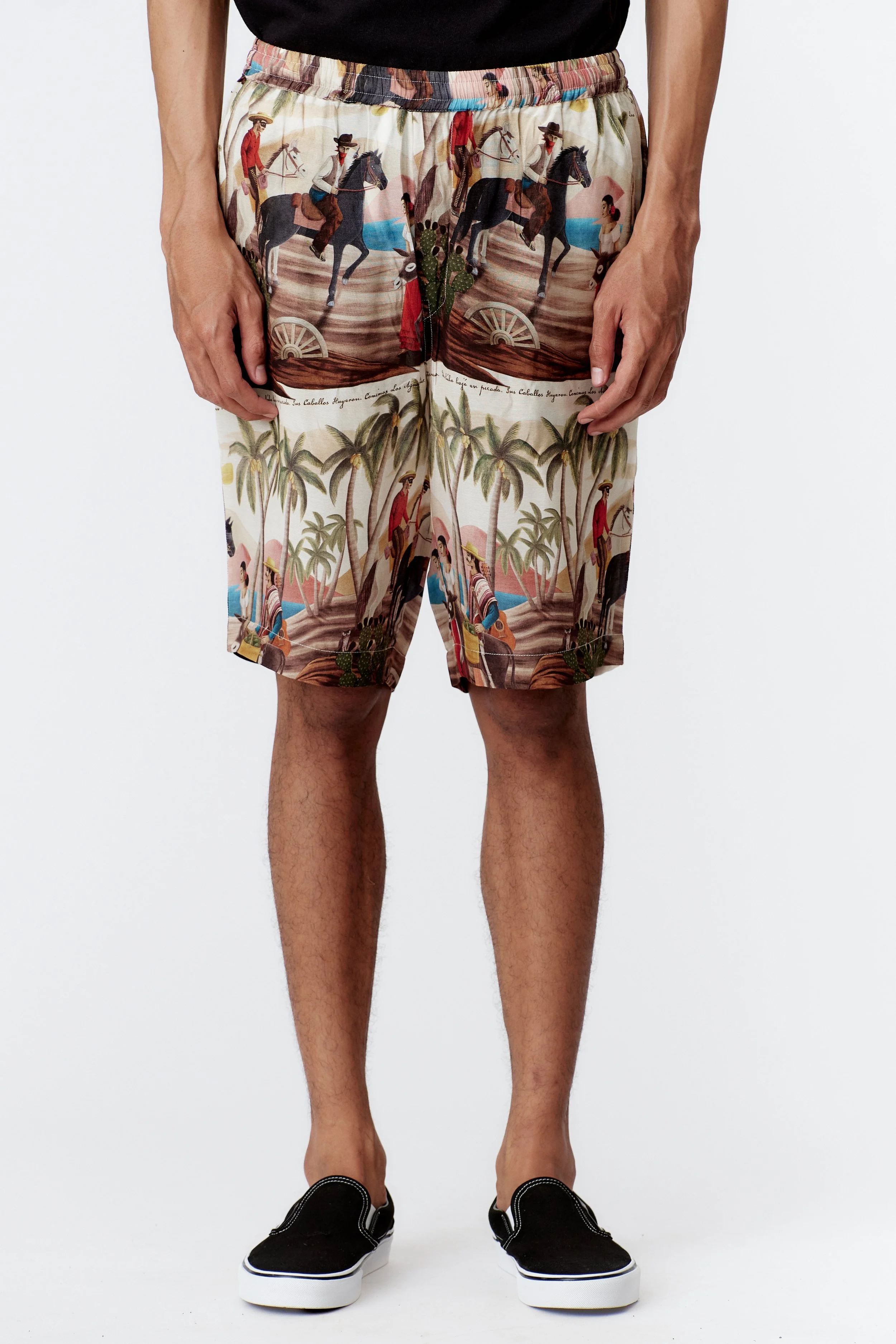 Hem detail showing repeating cactus and owl motif on off white fabric