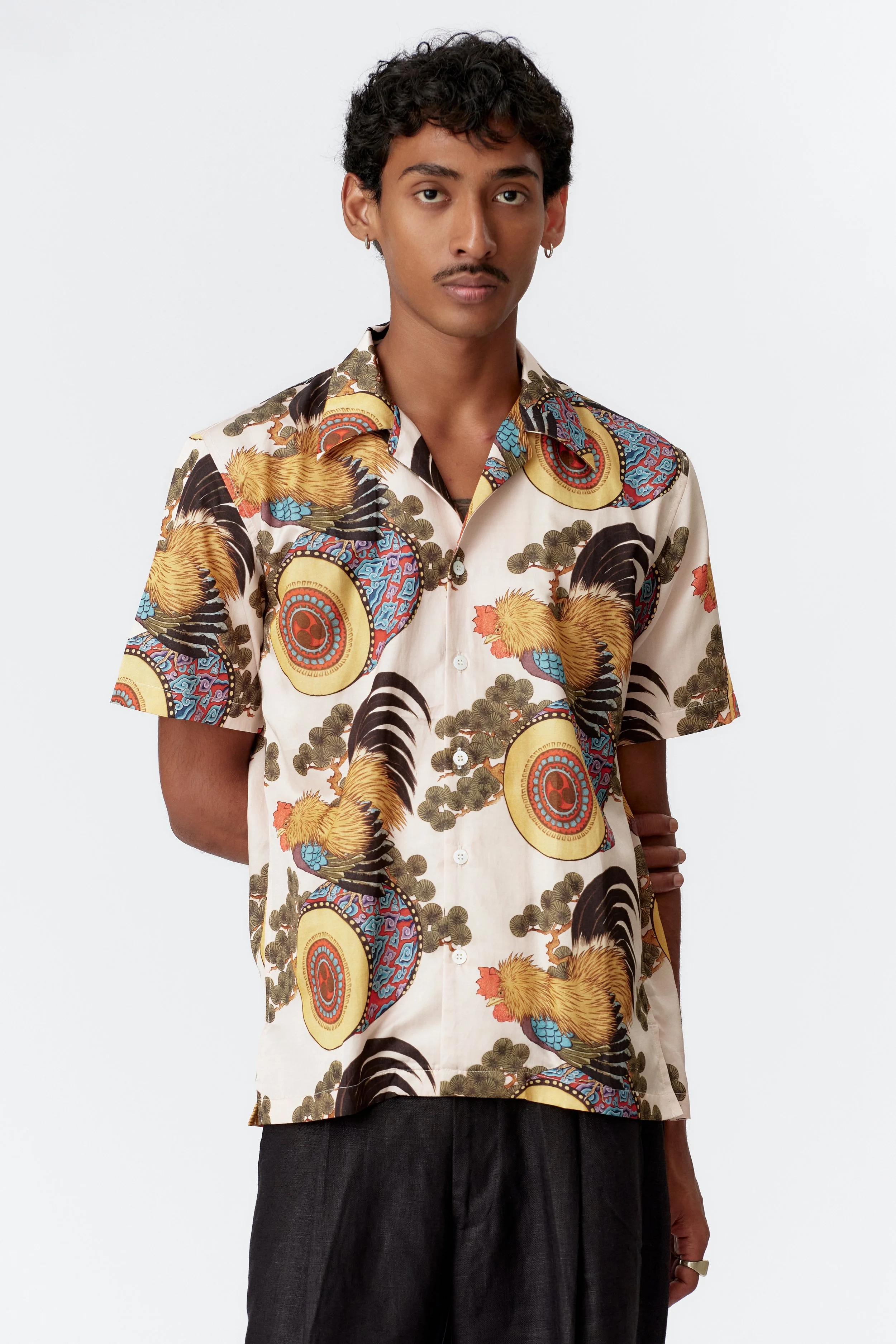 Three-quarter front view of cream Rooster Drum camp collar shirt in 60% silk 40% cotton