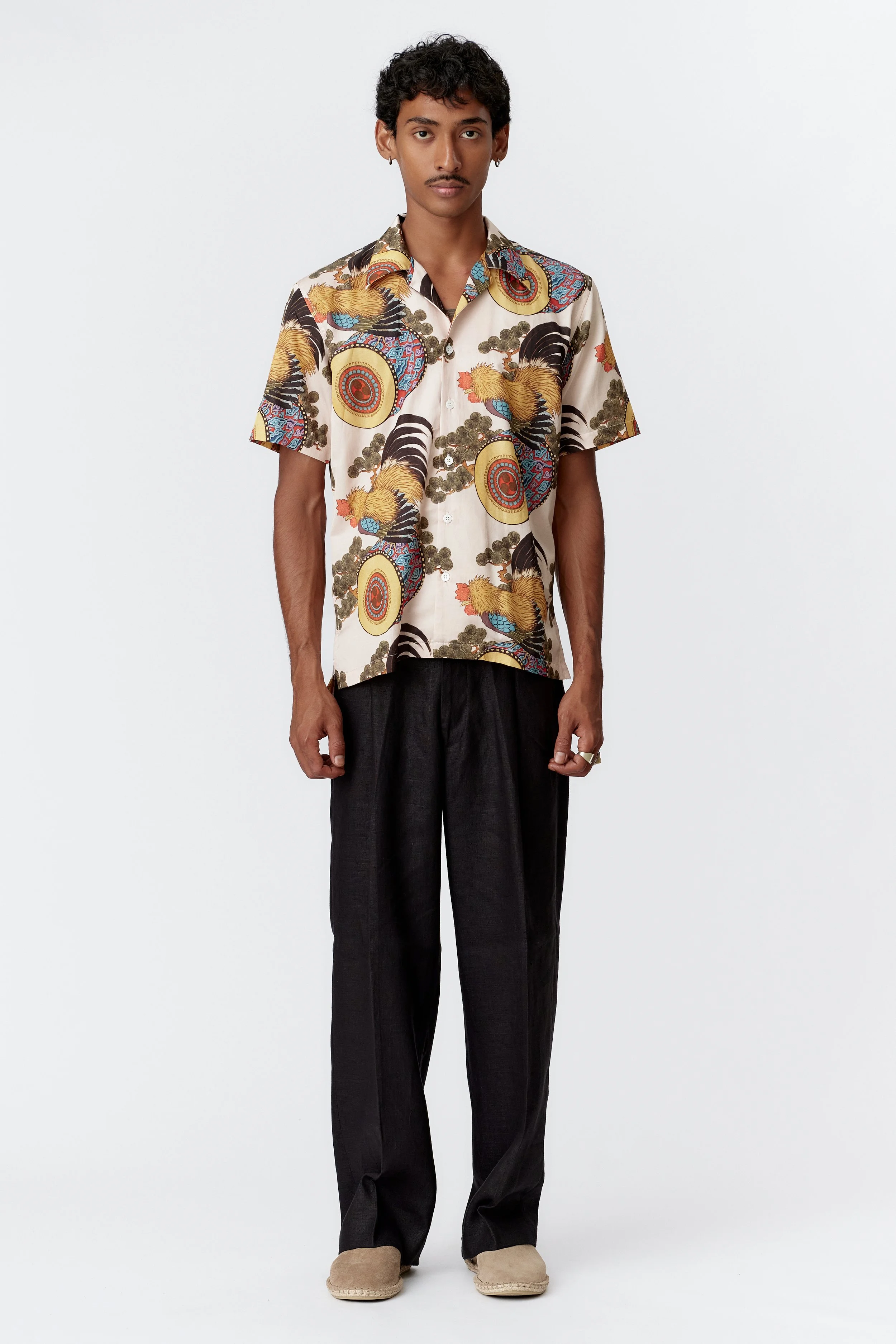 Full front view of Rooster Drum cream silk cotton short sleeve shirt with multicolour woodblock-style rooster print