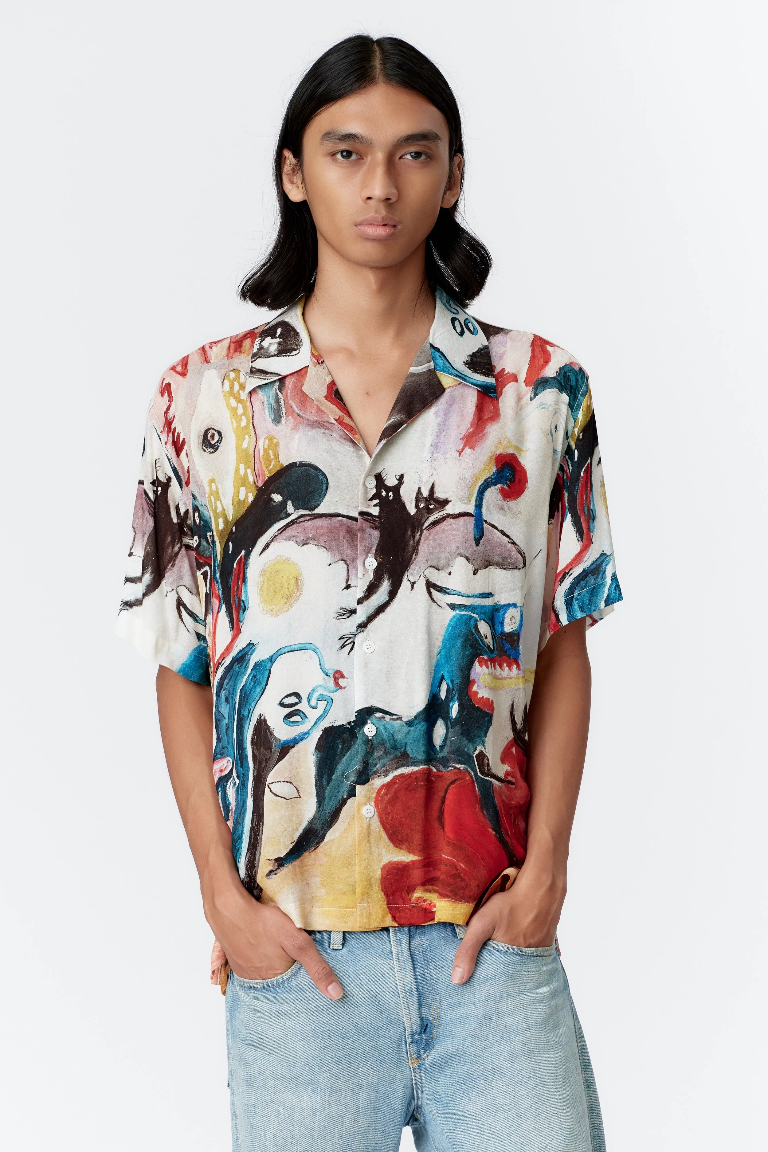 Close-up of MAD AS HELL crepe rayon shirt artwork depicting delirious figures and fever-dream motifs