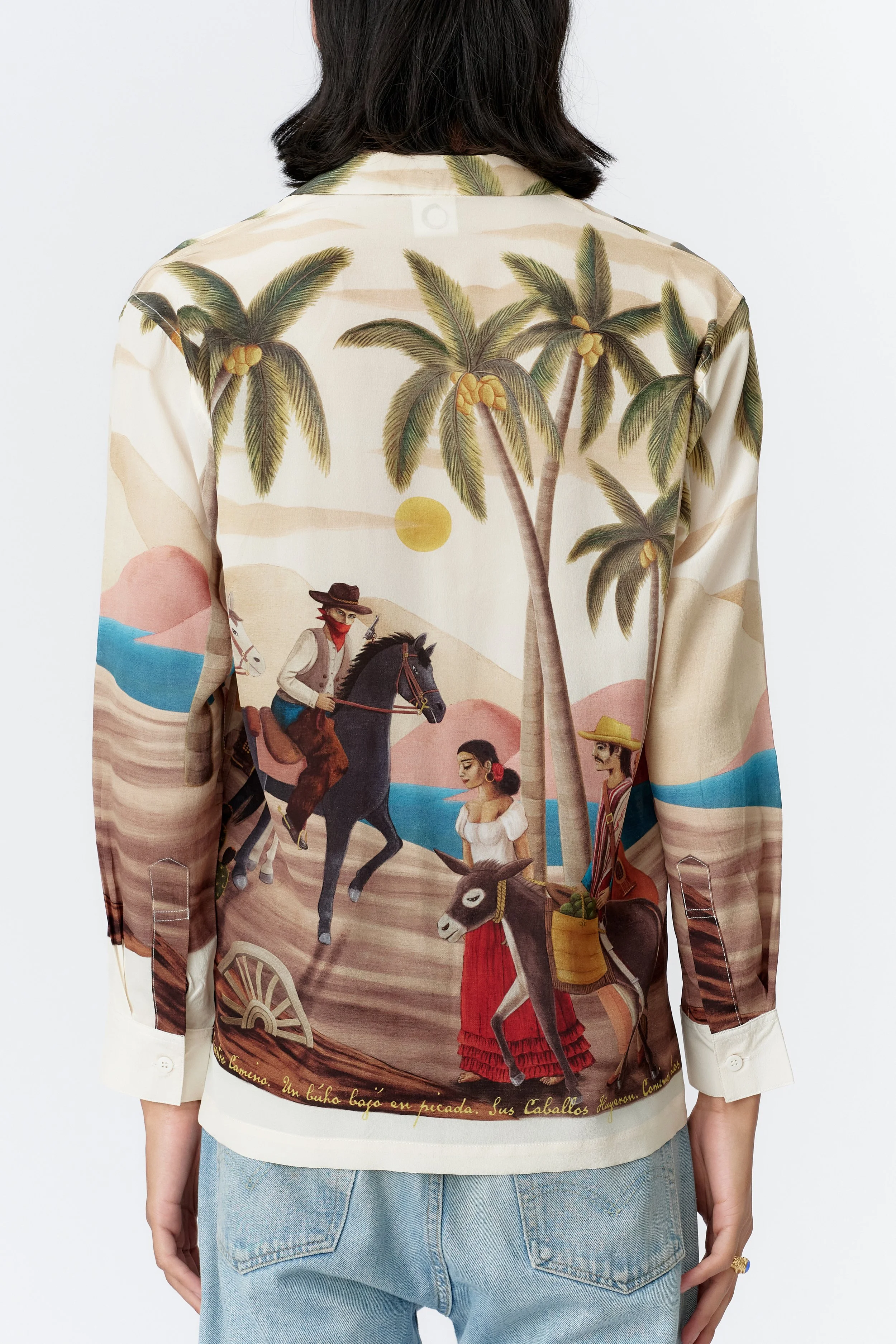 Back view of Bandito Off White silk crepe shirt displaying Western-inspired landscape with palm trees and split-tone sky.
