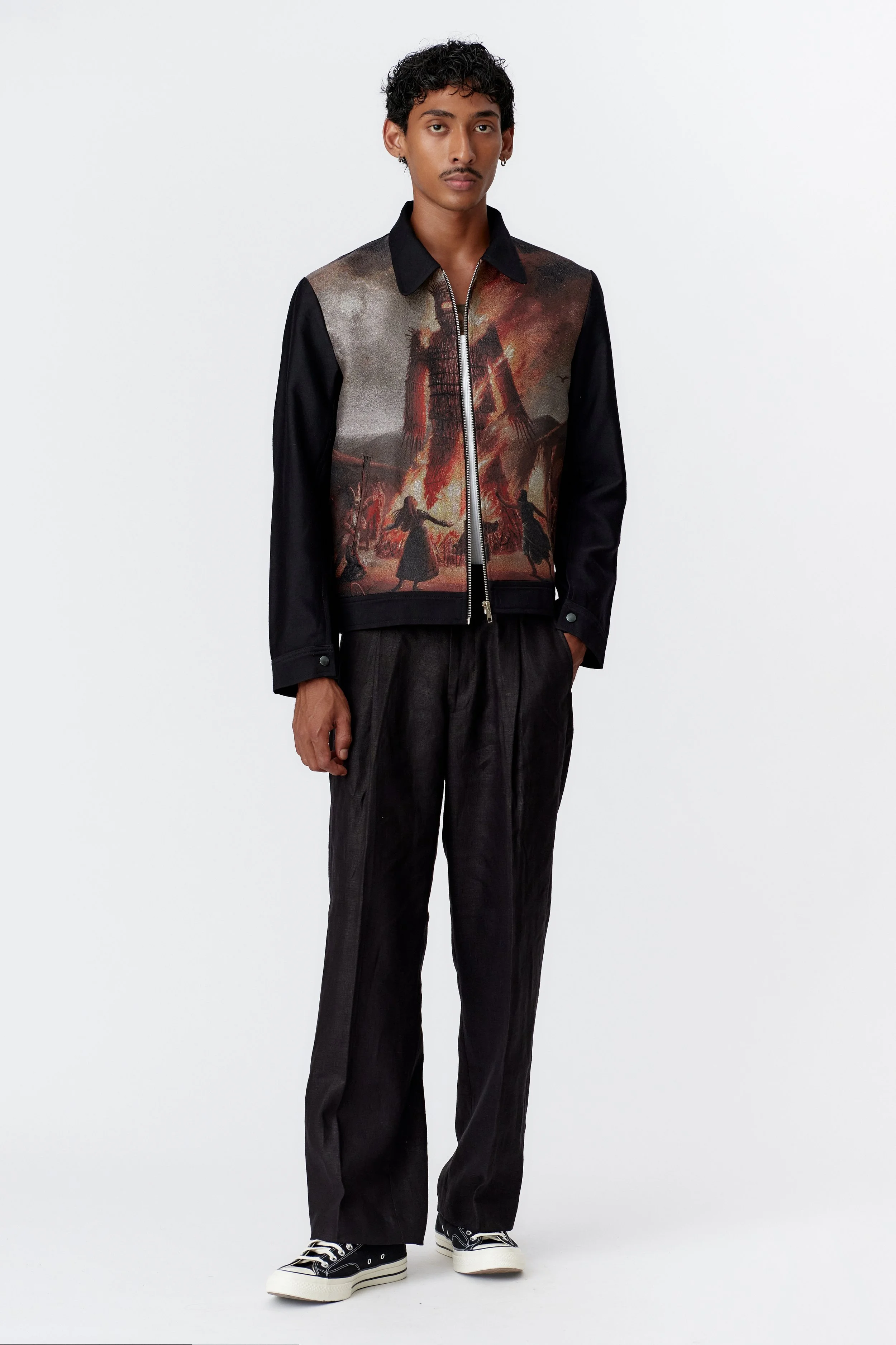 Full view of black blouson jacket highlighting contrasting front panel artwork