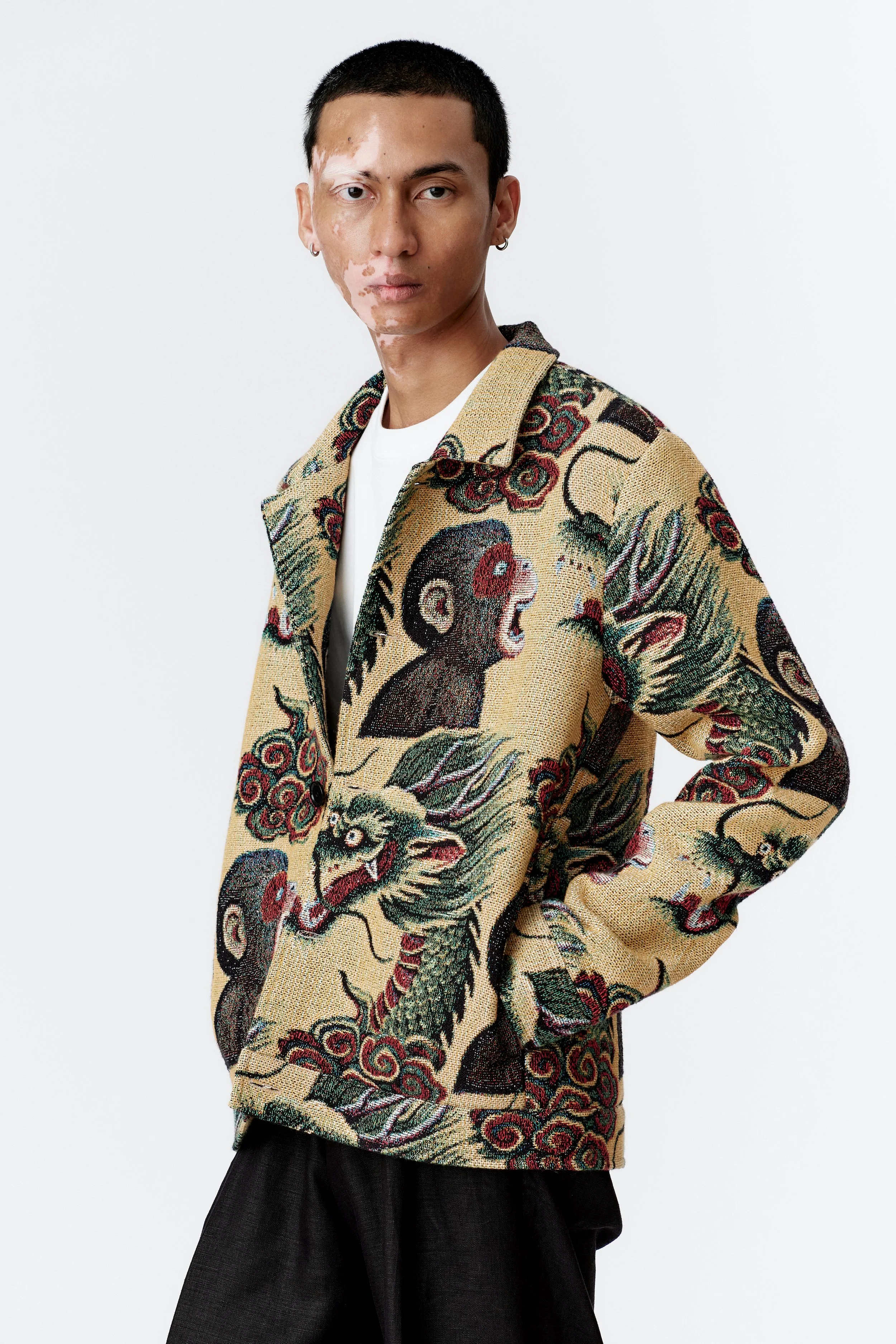 Side profile of model with hand in pocket wearing organic cotton chore jacket