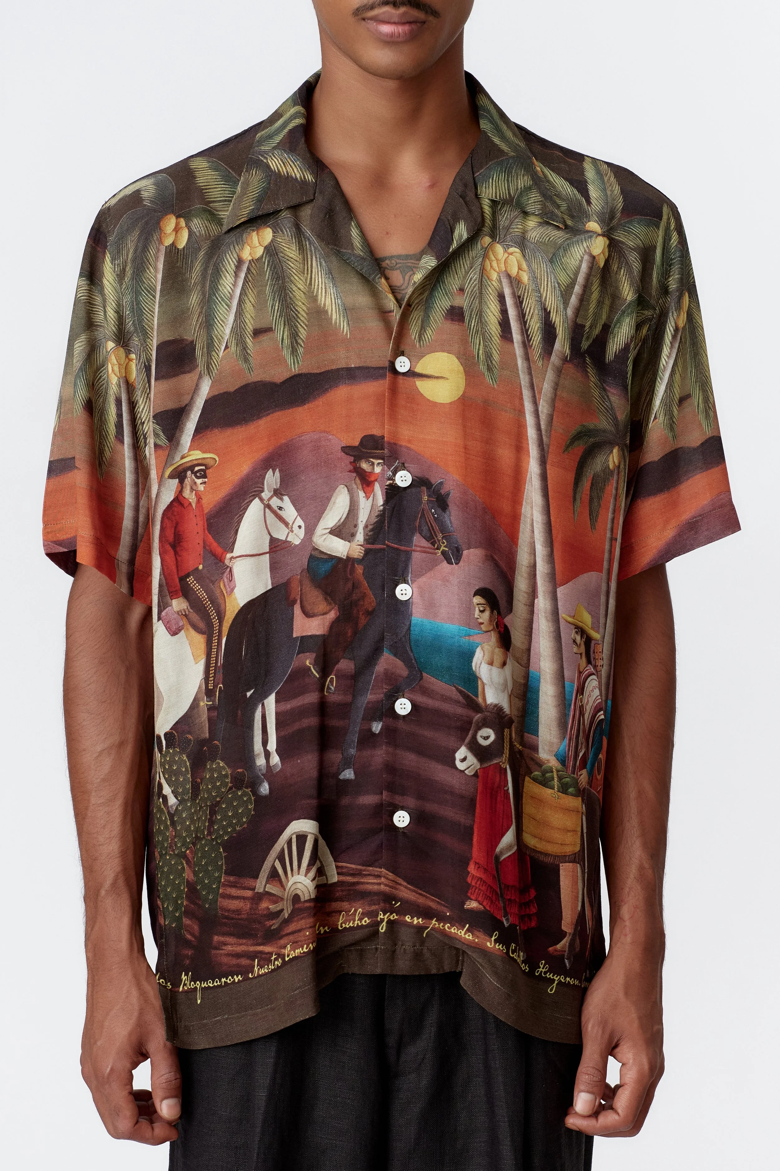 Close-up detail of silk rayon fabric showing cowboys, farmer, and donkey illustration