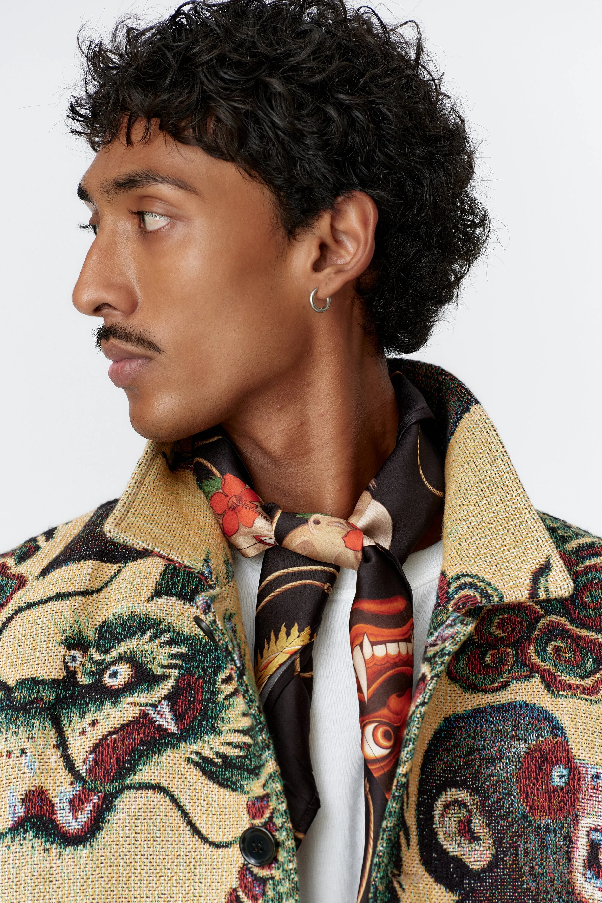 Close-up collar detail styled with Topeng silk scarf
