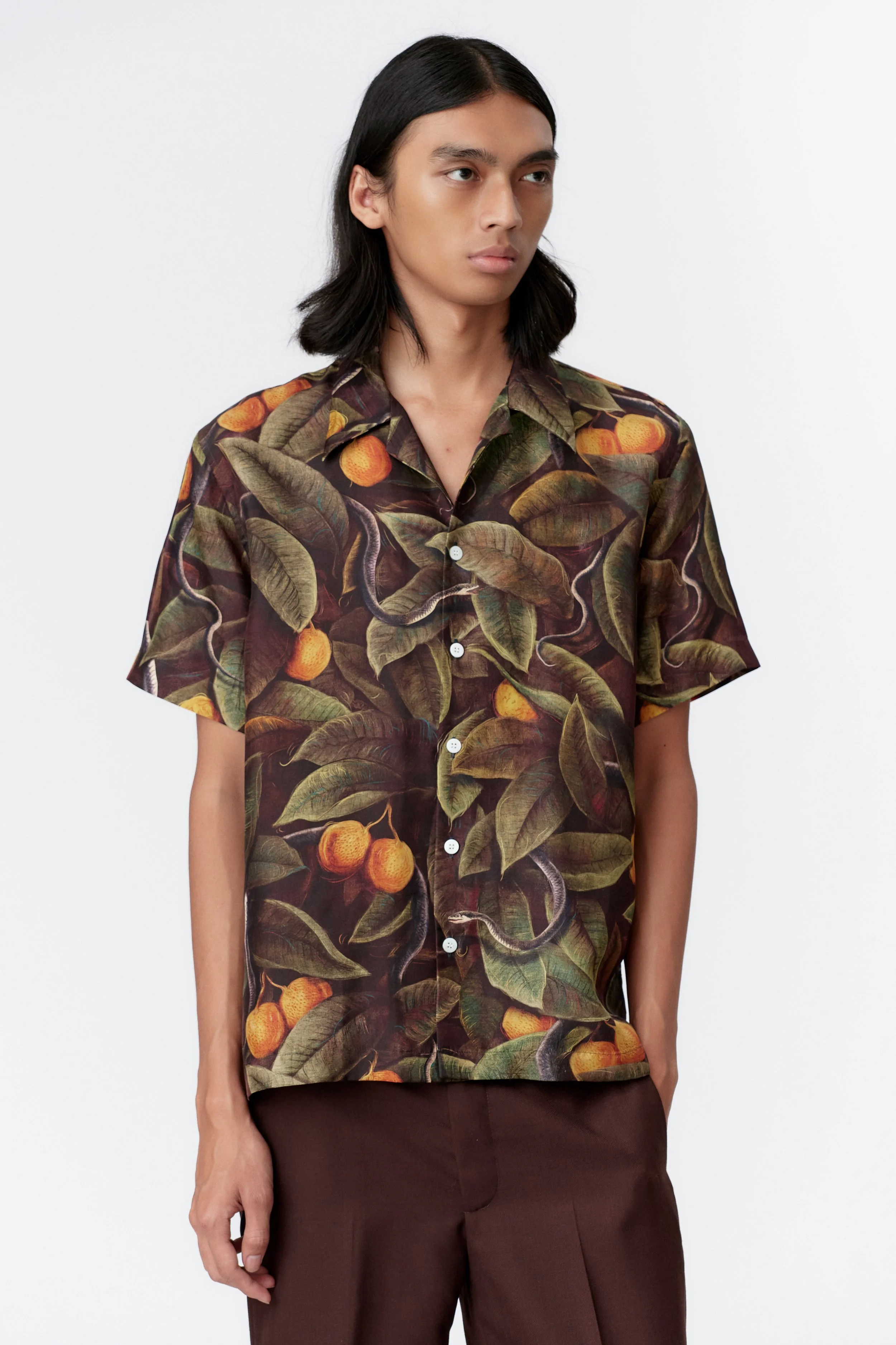 Close-up of SNAKER silk satin shirt artwork depicting coiled snakes and sacred foliage by Stevie Anderson