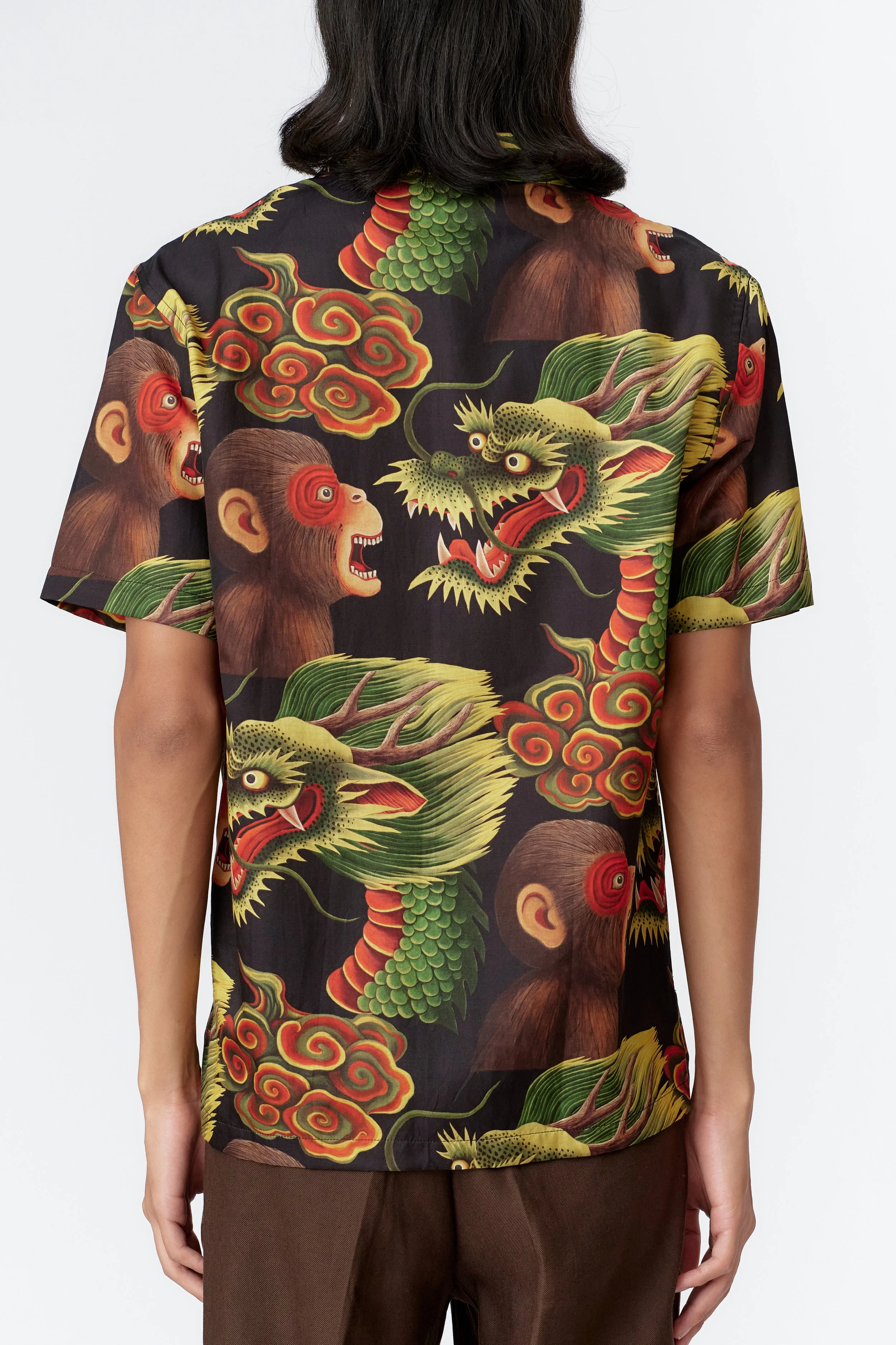 Back view of Monkey Dragon Black silk cotton shirt displaying surreal cloud and landscape illustration.