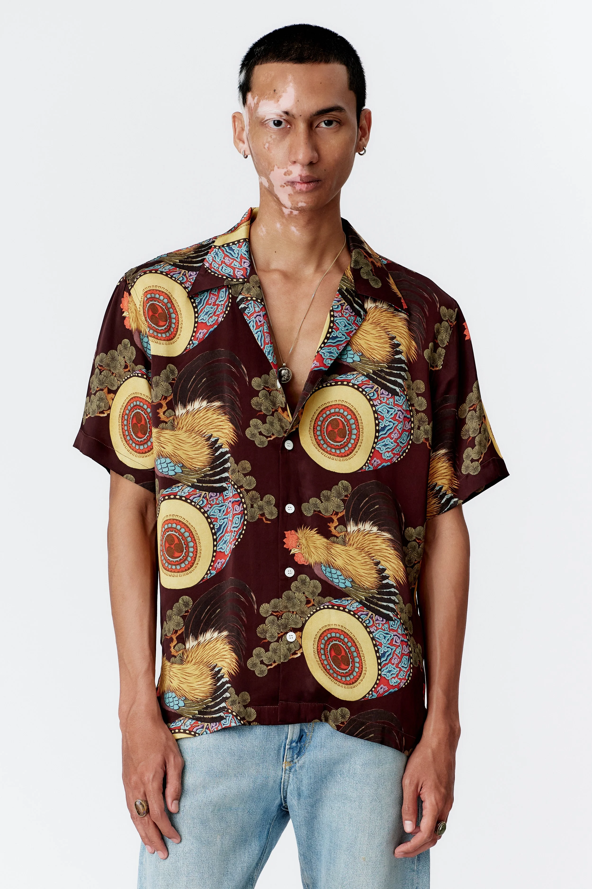 Editorial style image of model wearing Rooster Drum Wine luxury silk shirt.