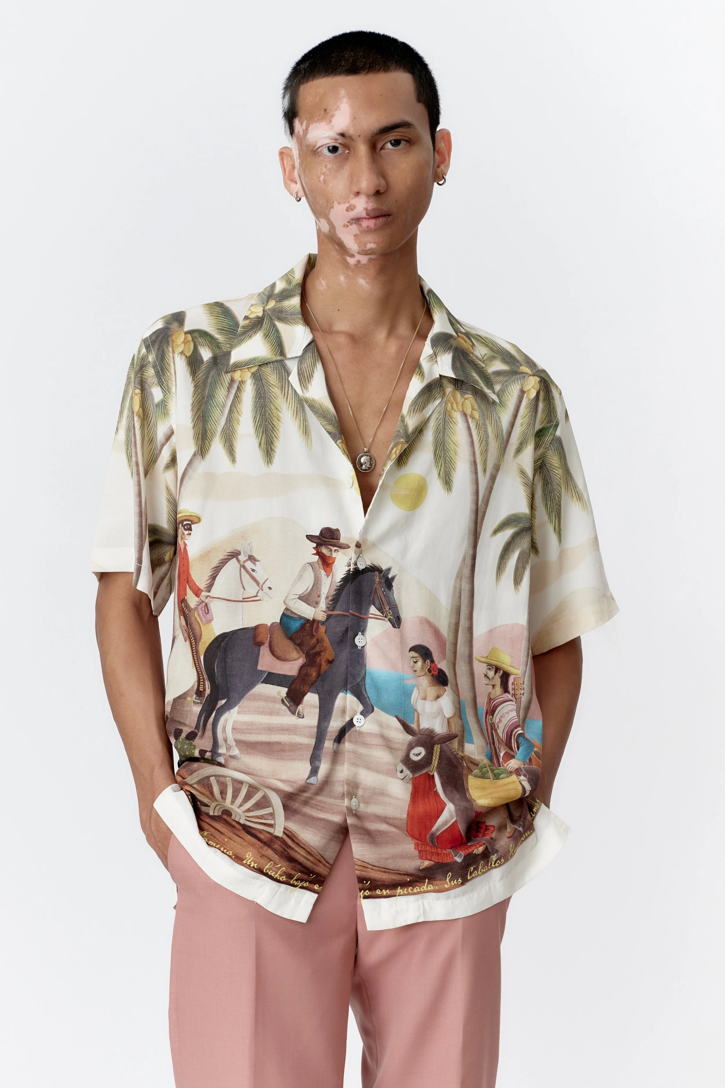 Close-up of camp collar and mother of pearl buttons on off white modal shirt