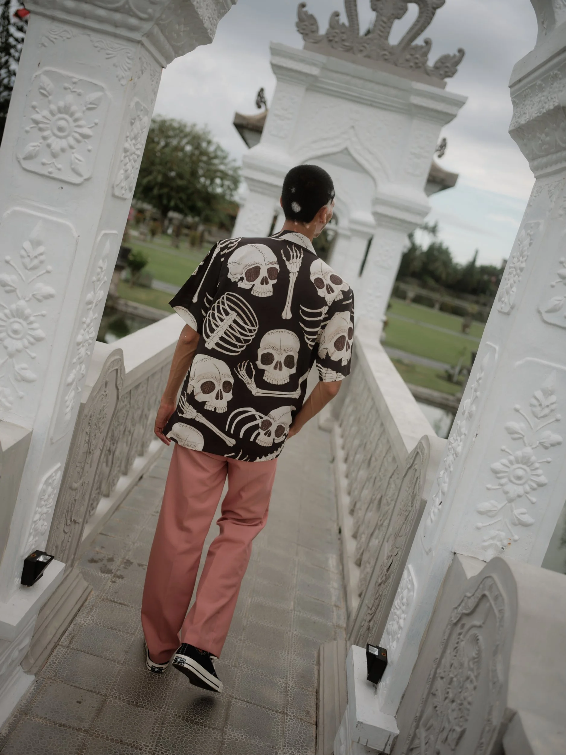 model wearing black and white skull print artwork on shirt in bali