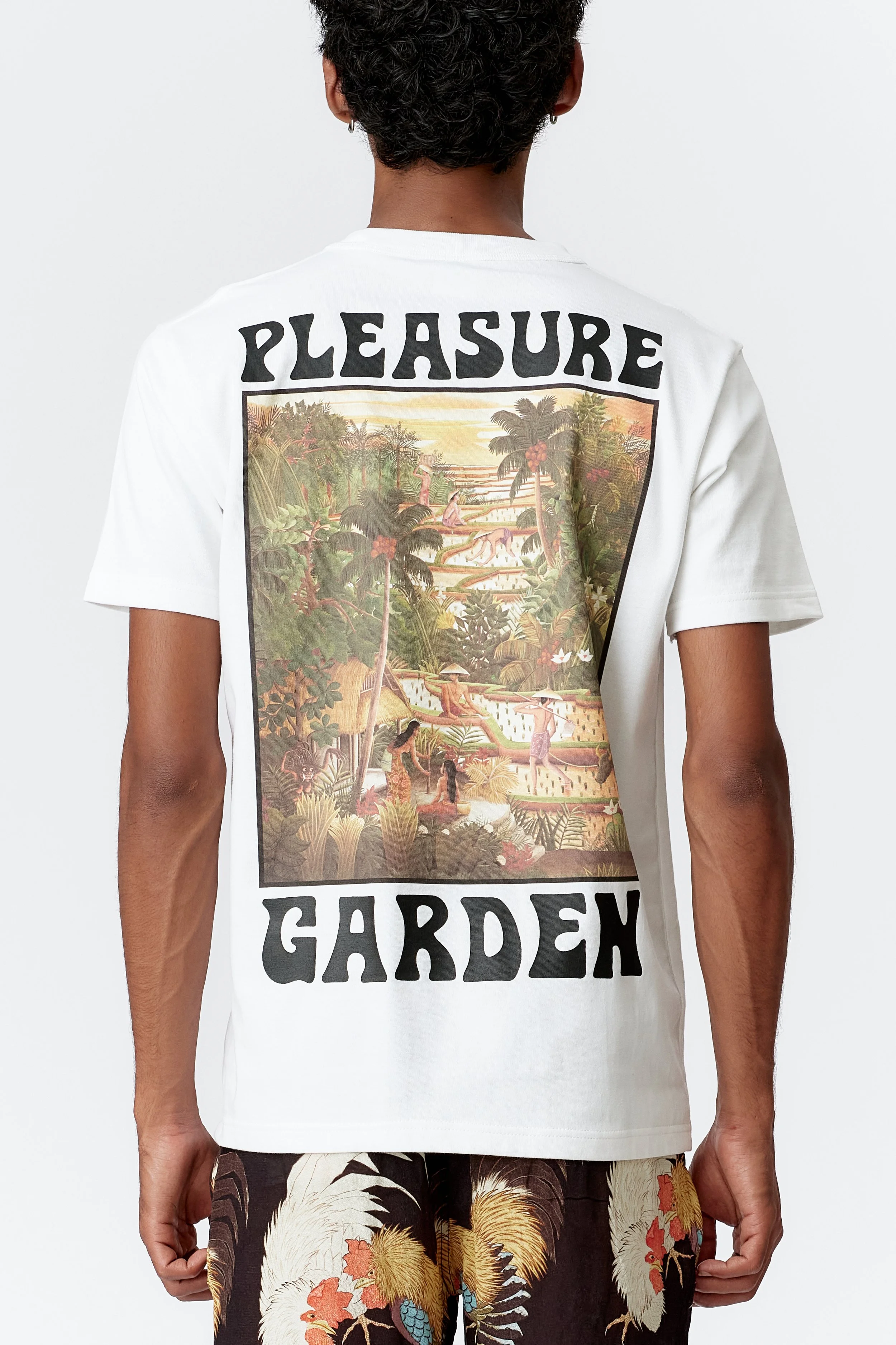Close-up of Subak-inspired back print showing terraced paddies and melting sunset sky