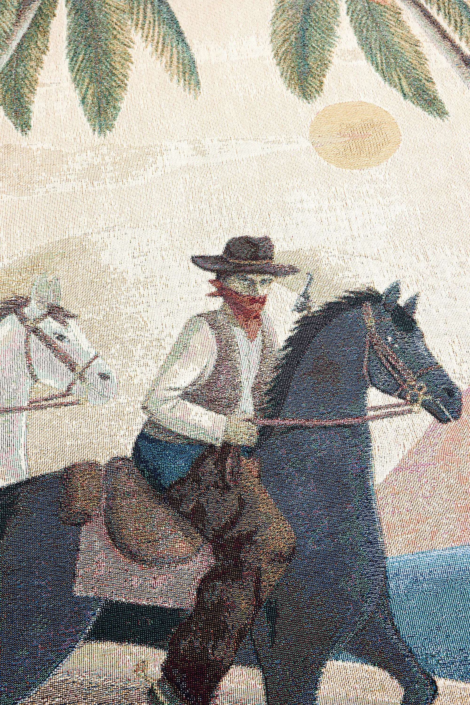 Detailed close-up of the woven desert standoff scene on the Bandito art blanket.