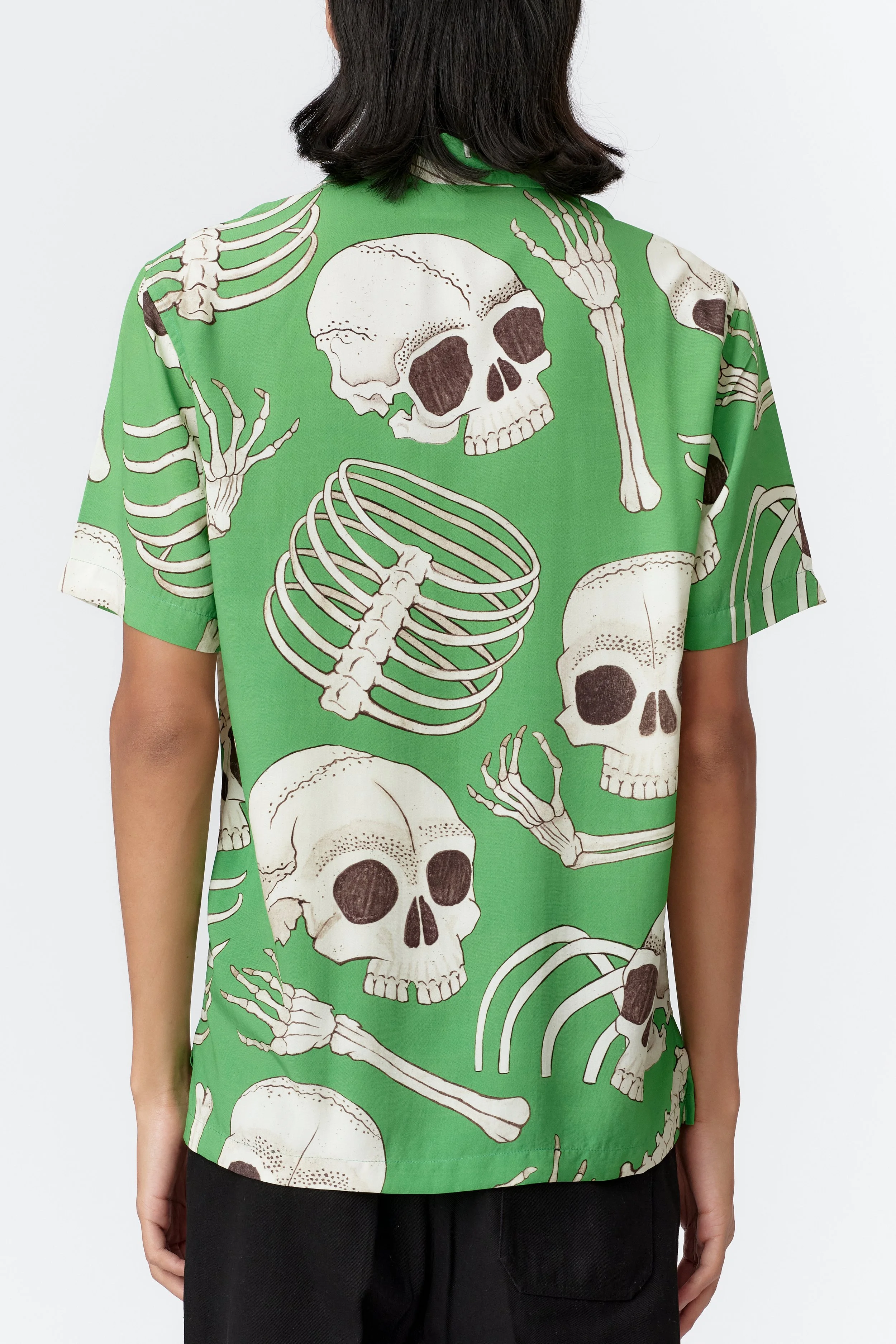 Back view of Skeleton green shirt featuring large-scale skeletal illustration