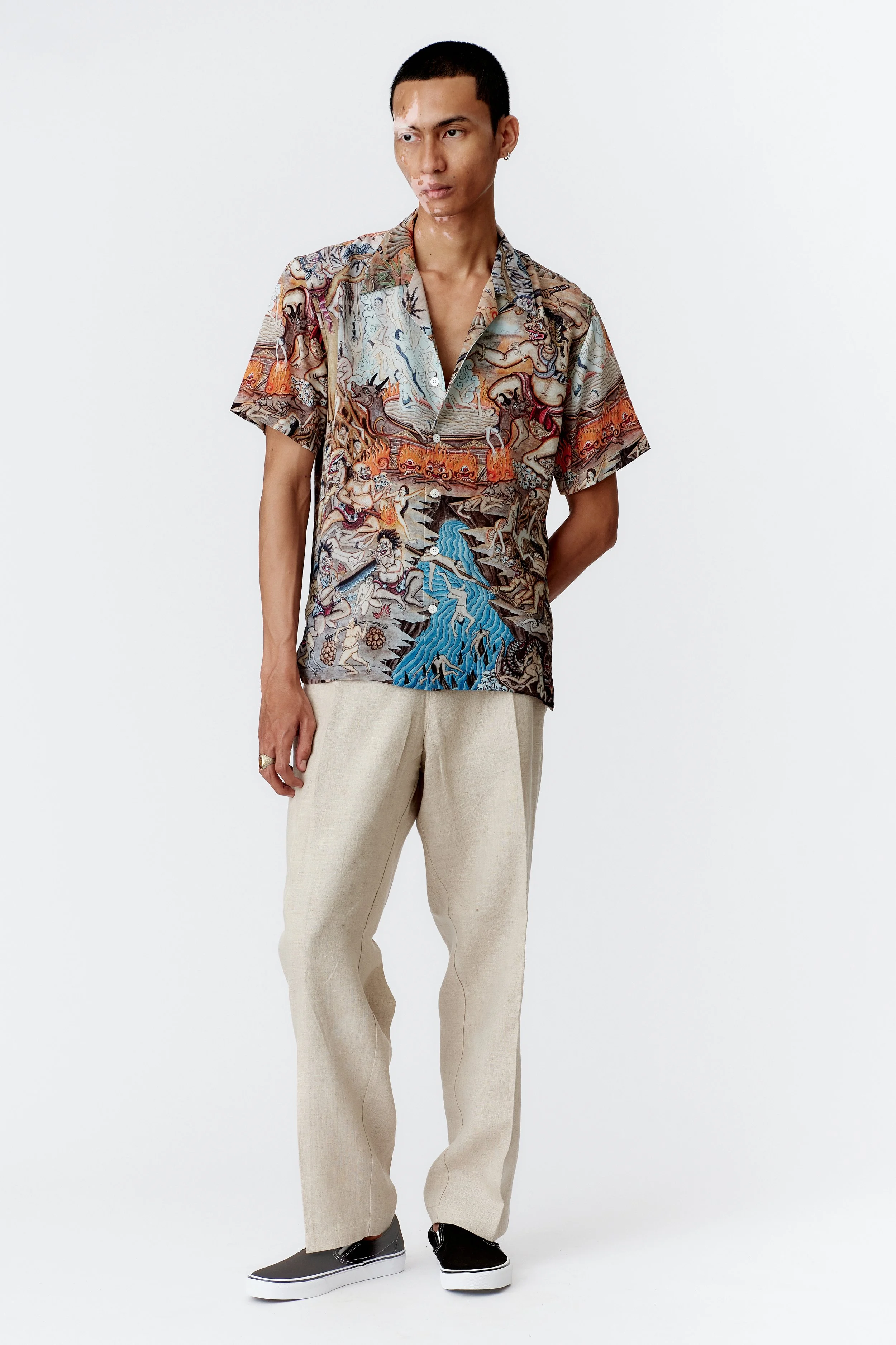 Model wearing Atma Penangsaran 100% silk crepe short sleeve shirt, full front view showcasing intricate mythological artwork and camp collar.