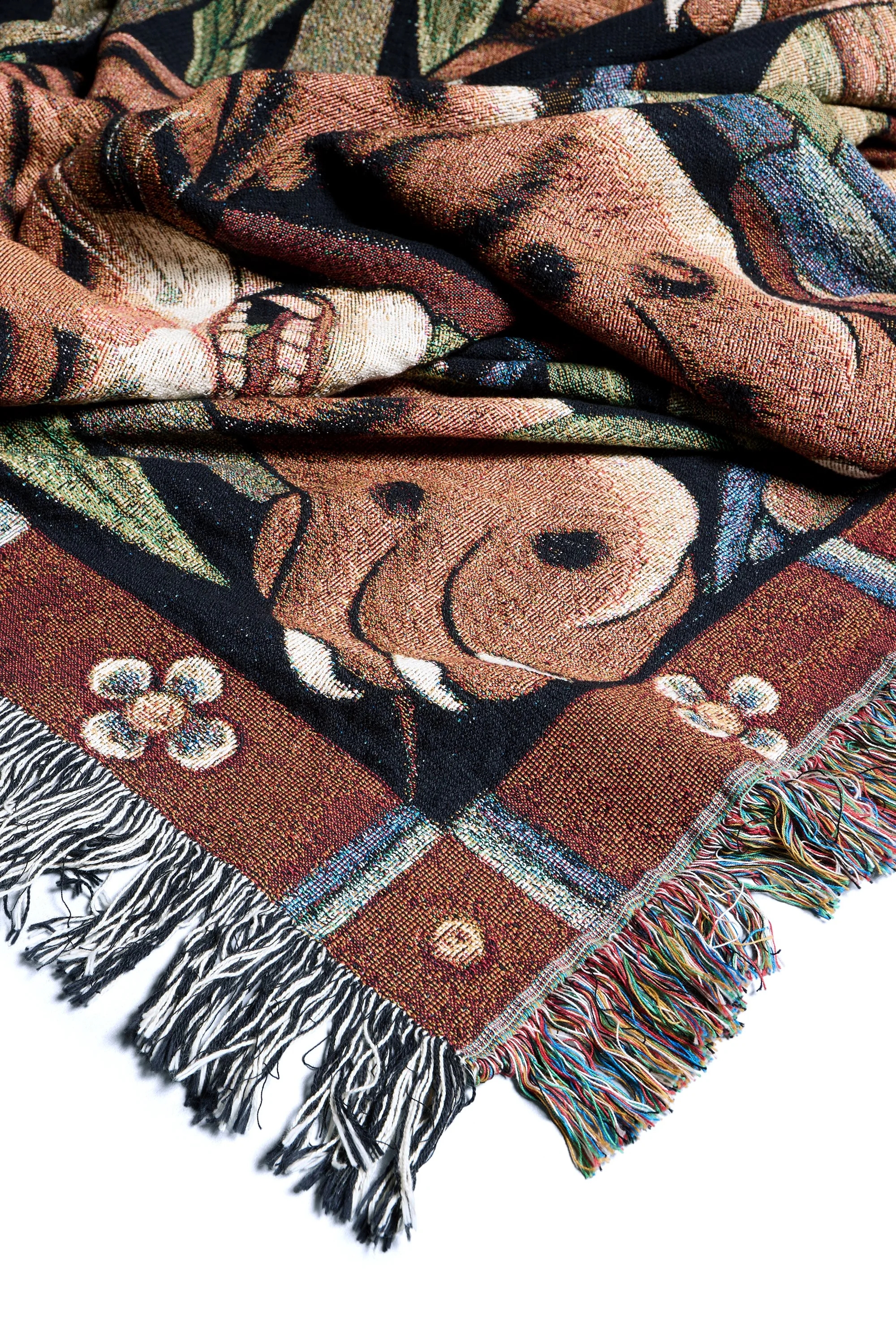Ornate border and woven cotton texture of Tiger Bamboo blanket with fringed edges