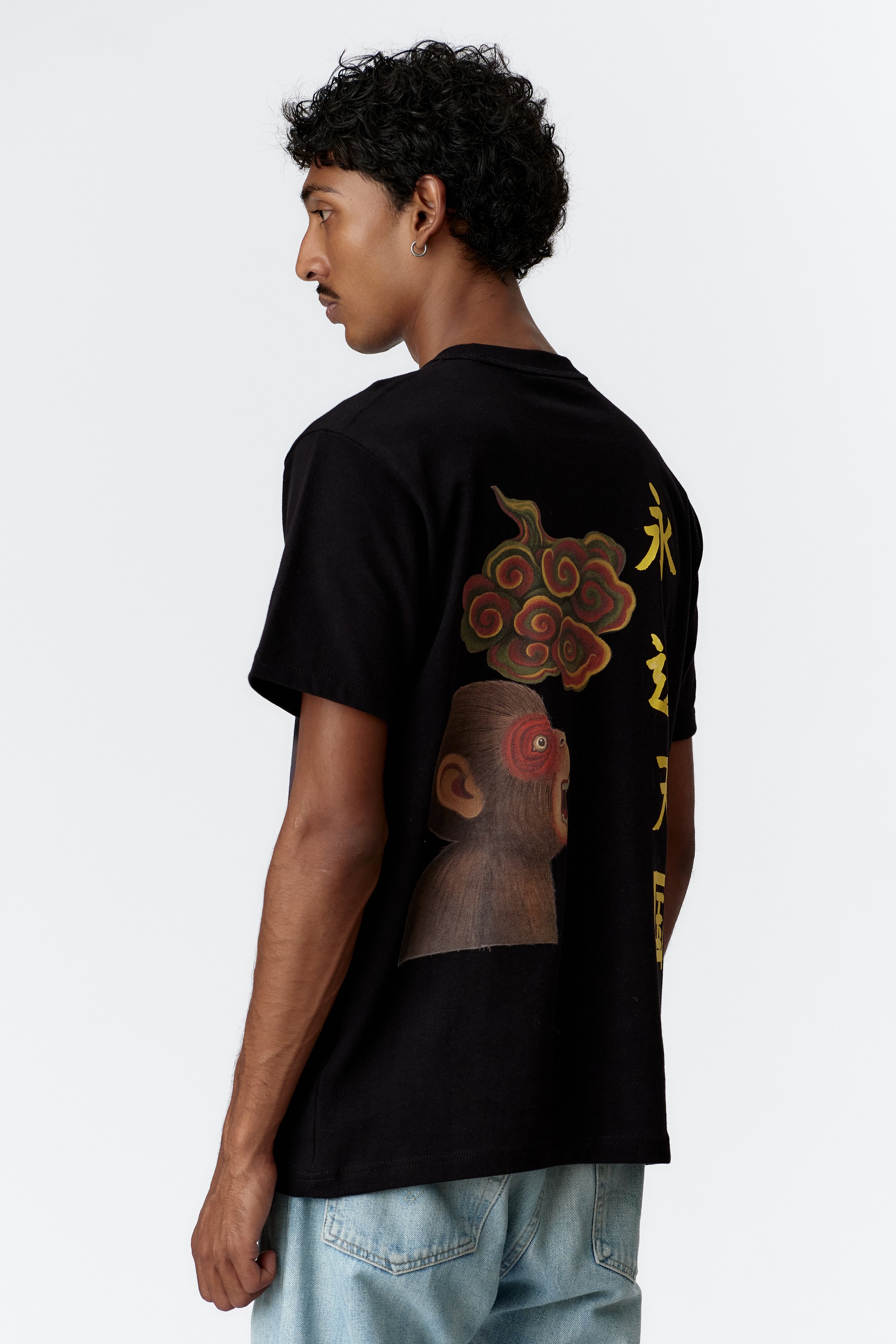 Side view of model exhibiting drape of sleeve and back print detail