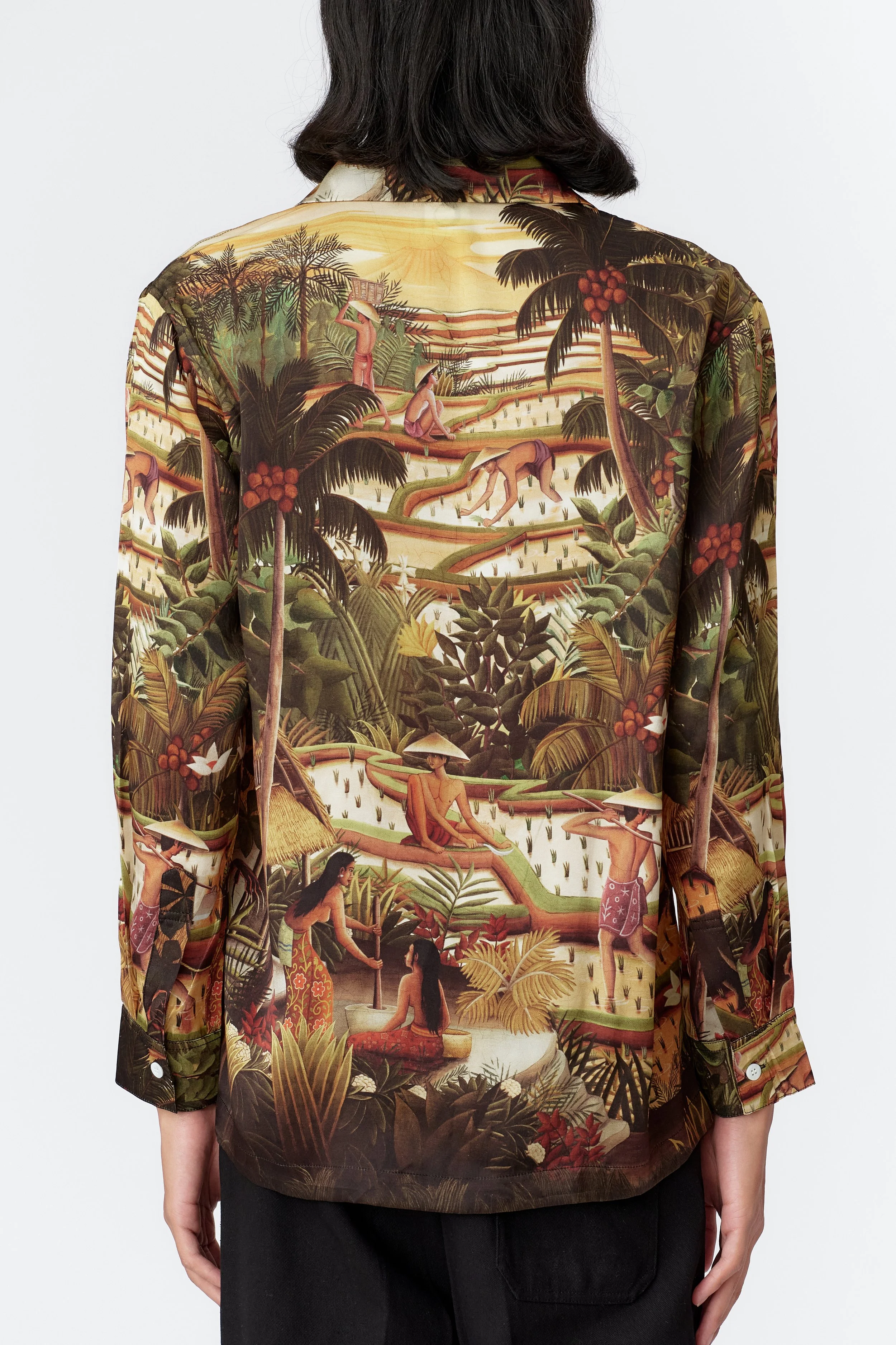 Back view of green silk satin shirt title subak featuring painting of bali by stevie anderson