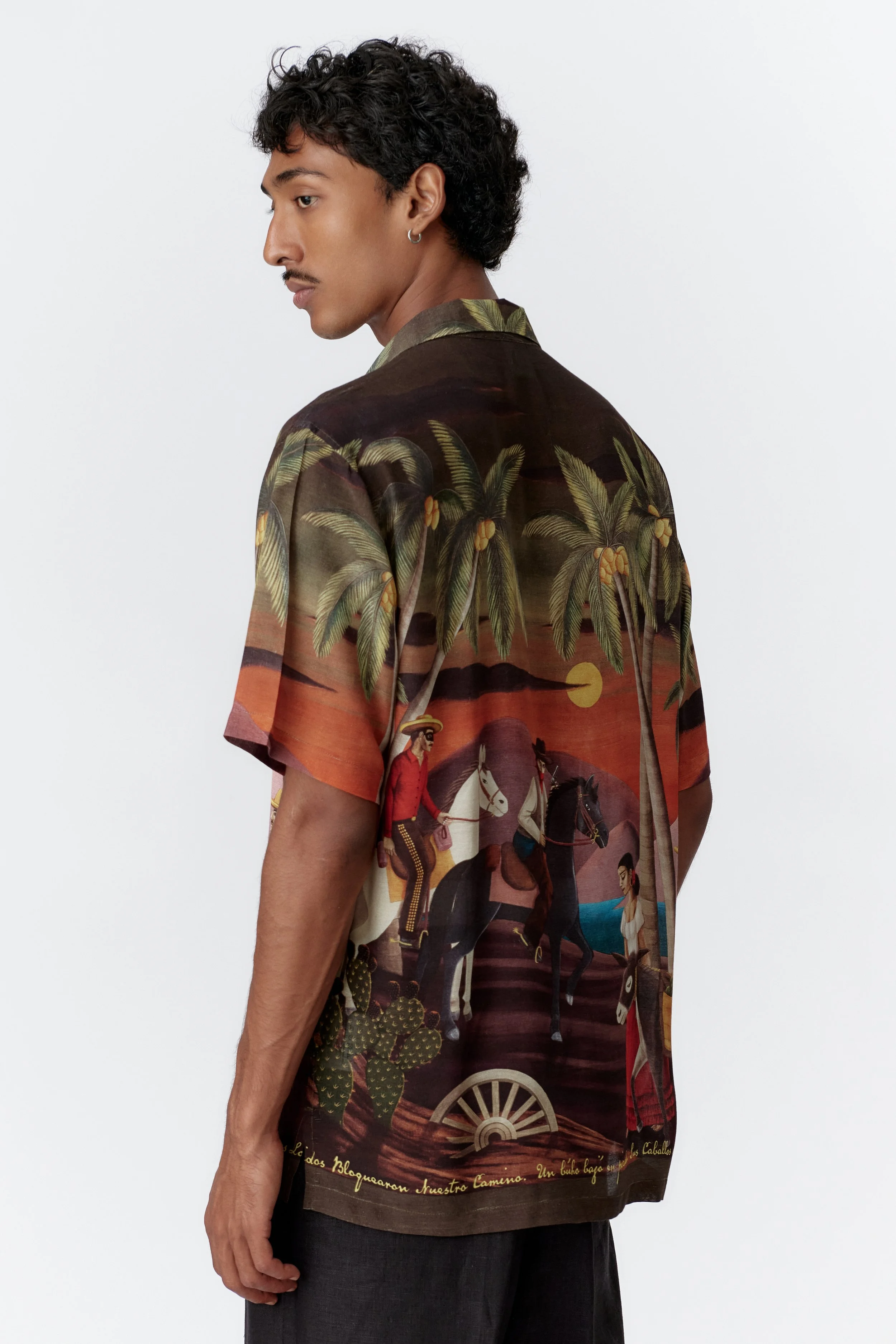 Side profile of model wearing green Bandito camp collar shirt with straight hem