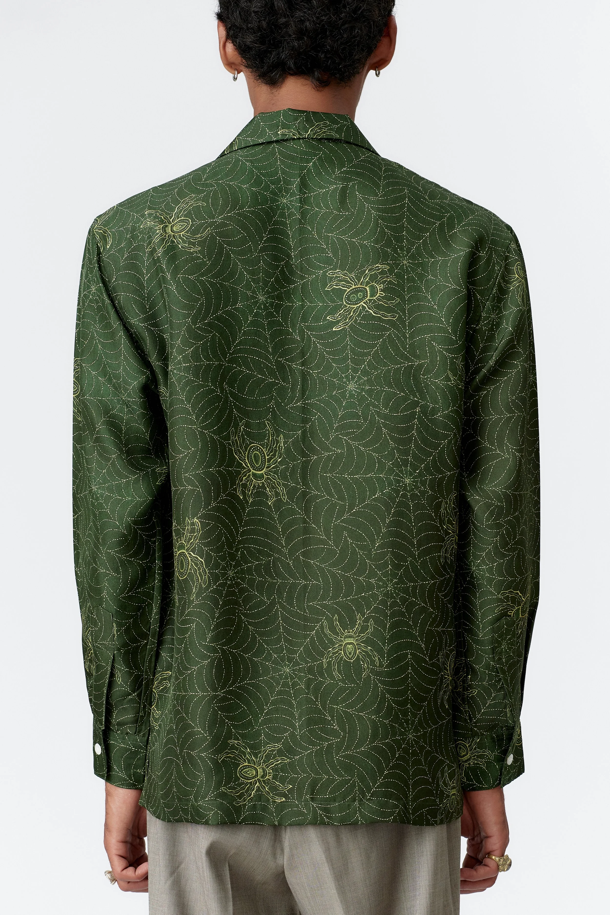 Close-up back view of geometric spider motif within golden web pattern